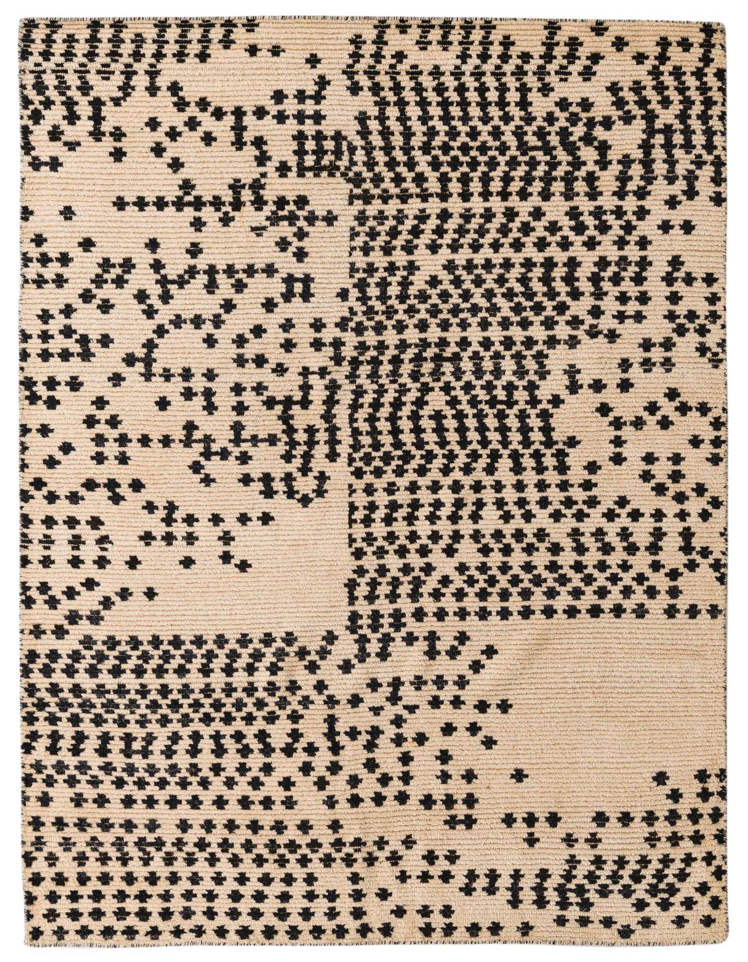 A 5x8 rectangular ivory wool rug with a modern abstract pattern of scattered black dots and shapes.