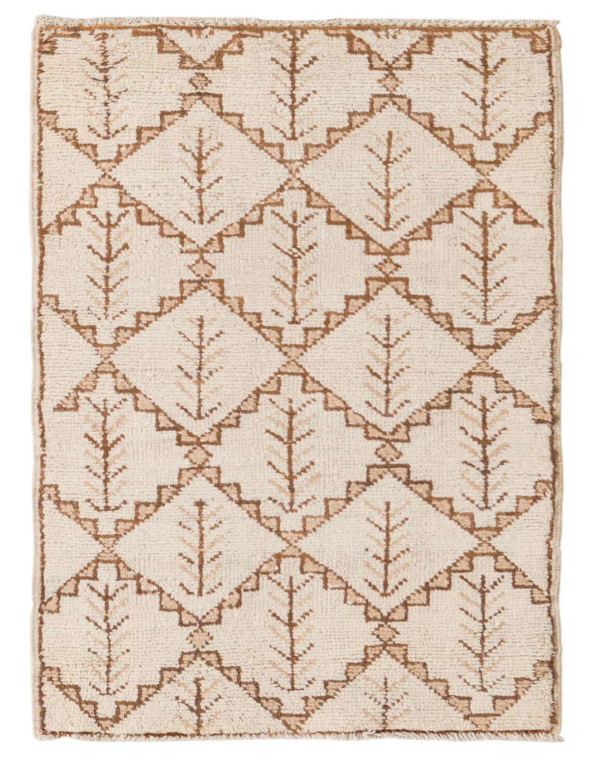 A 3x5 rectangular ivory wool rug with a modern abstract pattern of brown geometric diamonds and tree-like motifs.