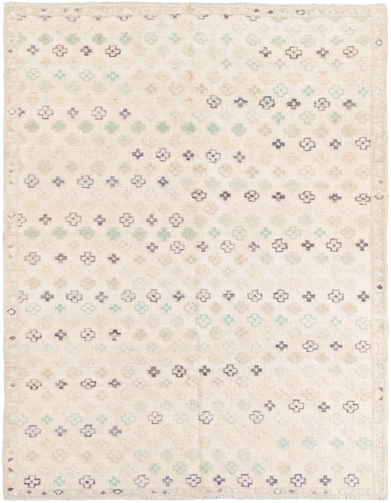 A 6x9 rectangular ivory wool rug with a modern pattern of small, scattered light blue and dark grey floral-like motifs.