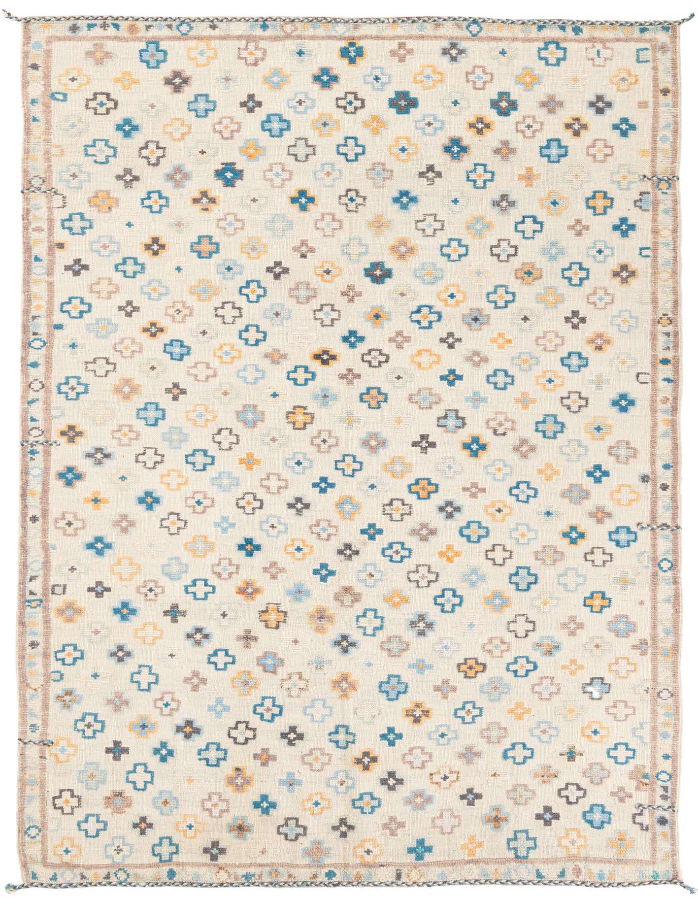 A 6x9 rectangular ivory modern wool rug with a repeating pattern of small blue, yellow, and brown geometric shapes.