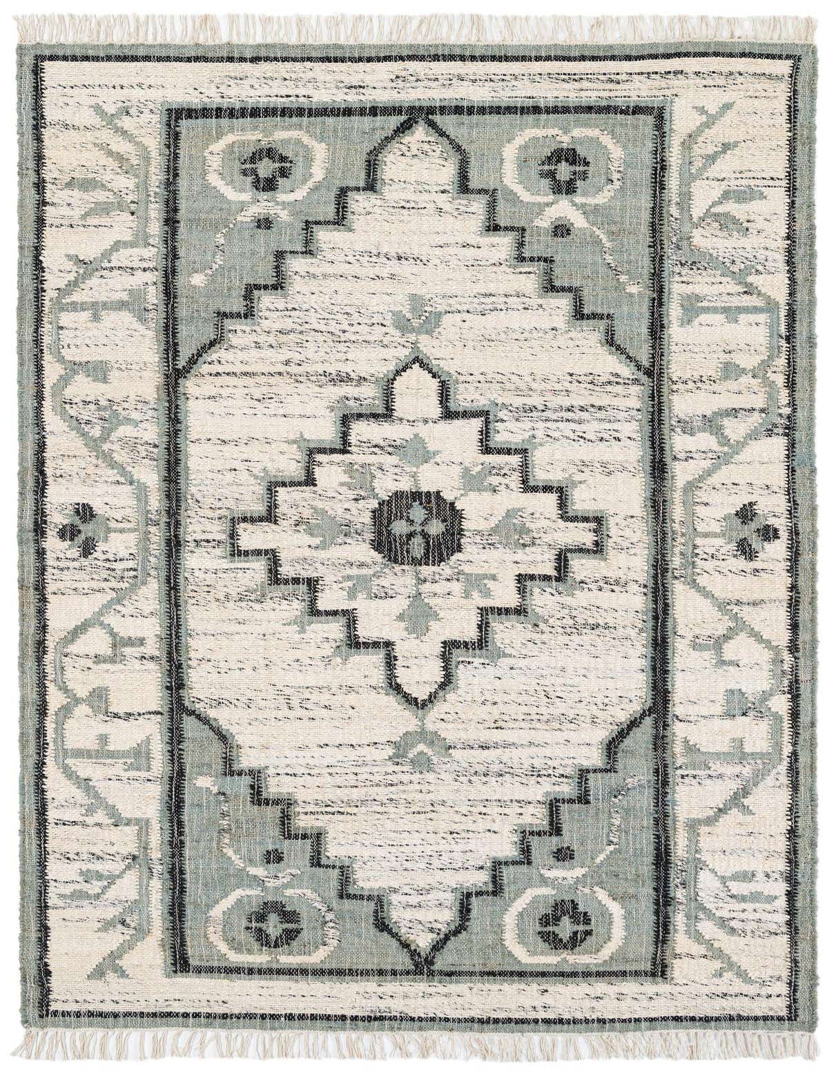 A 5x8 rectangular ivory and light blue Kilim Jute rug with a tribal medallion pattern and fringe.