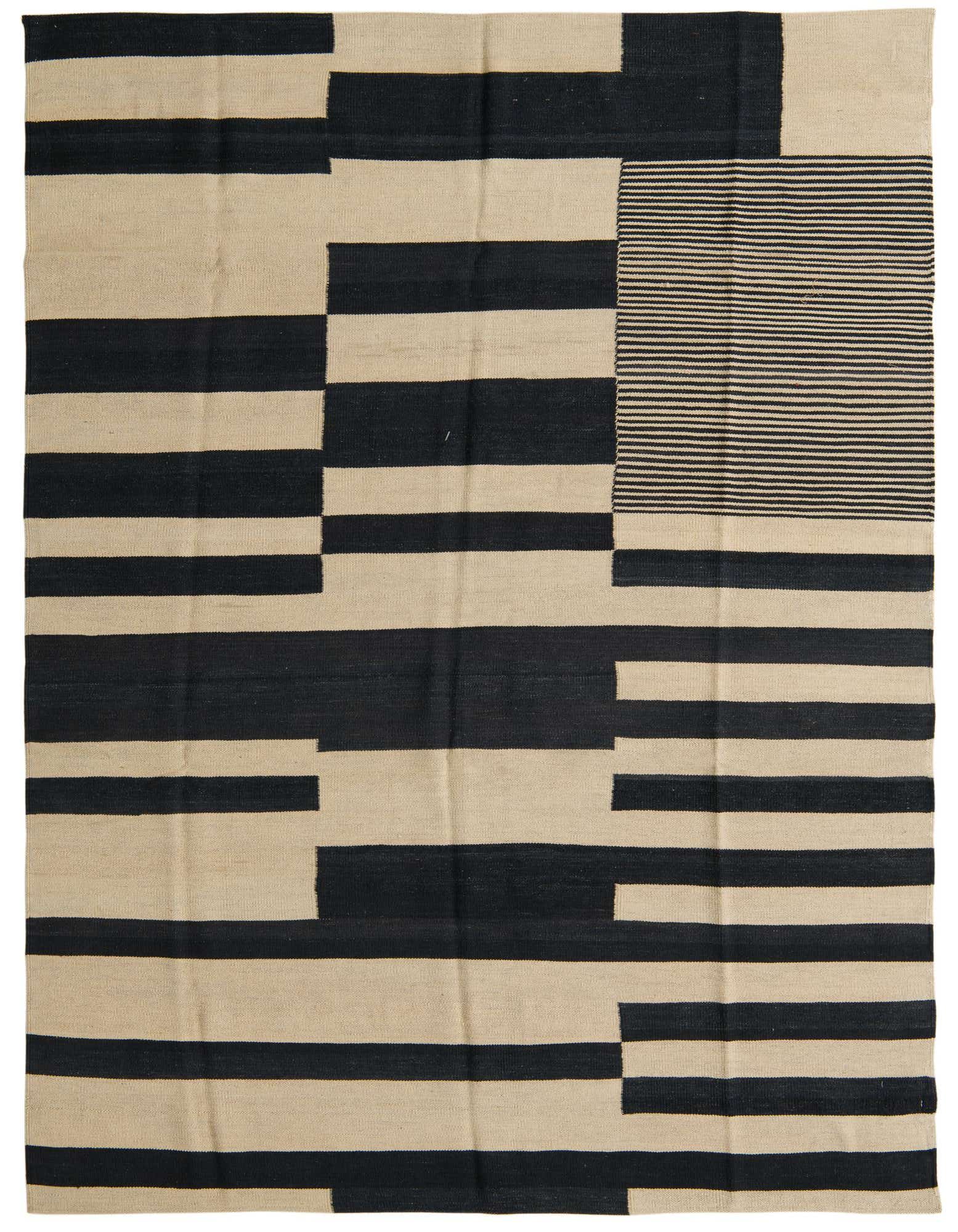 A 5x8 rectangular flatweave rug with a modern tribal pattern in black and ivory, ideal for a living room.