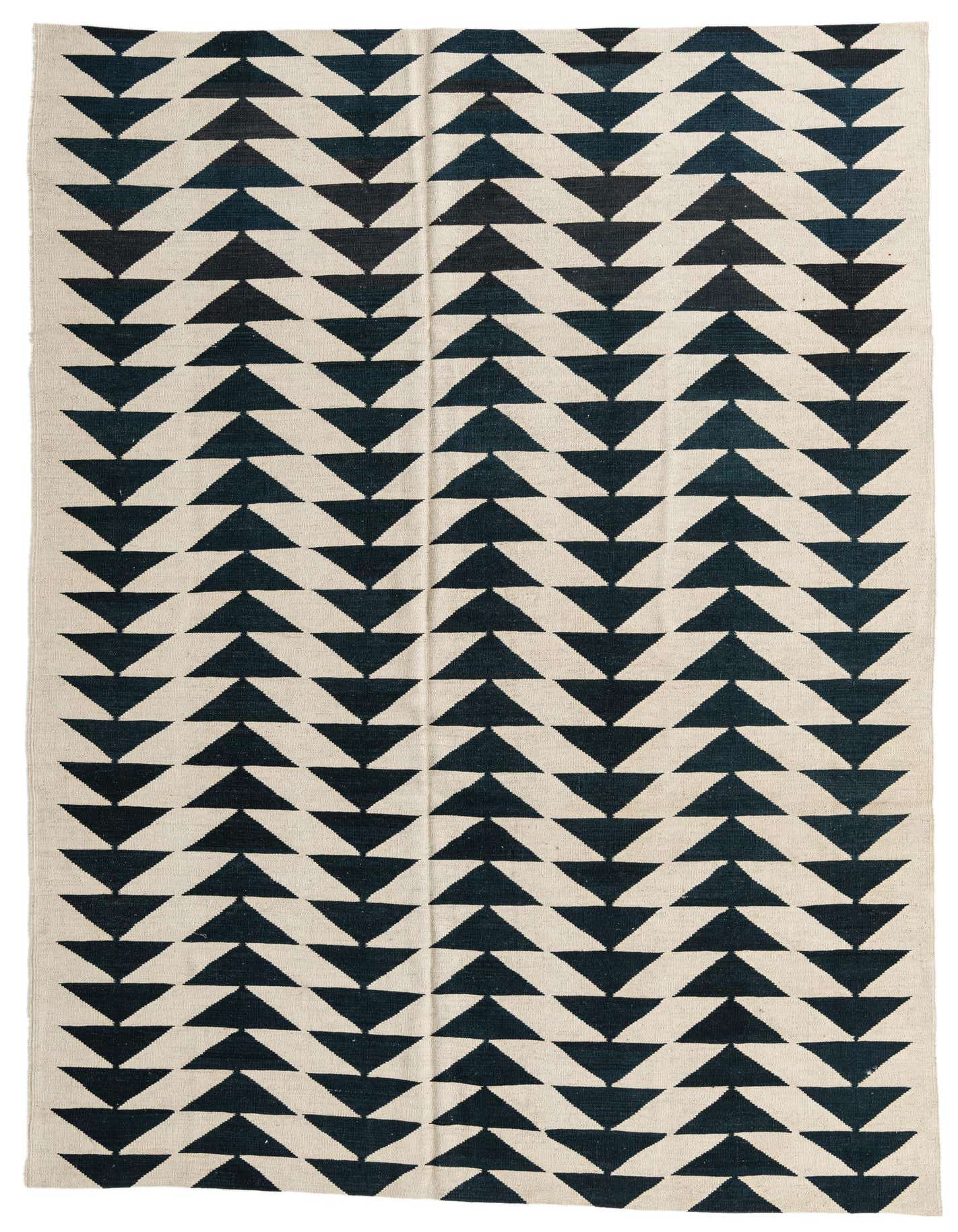 A 6x9 rectangular ivory and dark blue flatweave rug with a repeating tribal geometric triangle pattern.