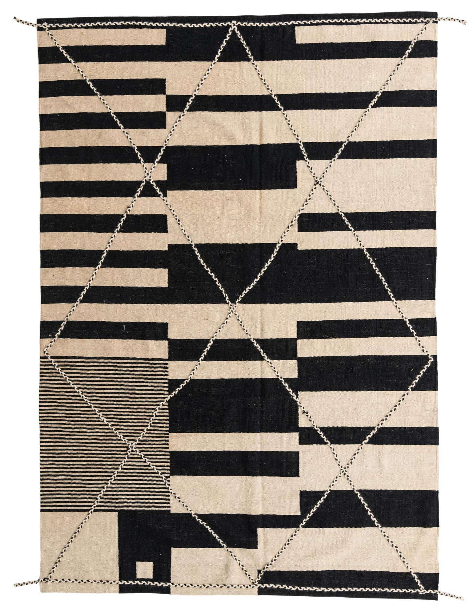 A 6x9 rectangular ivory and black tribal flatweave rug with a bold geometric pattern, perfect for a modern living room.