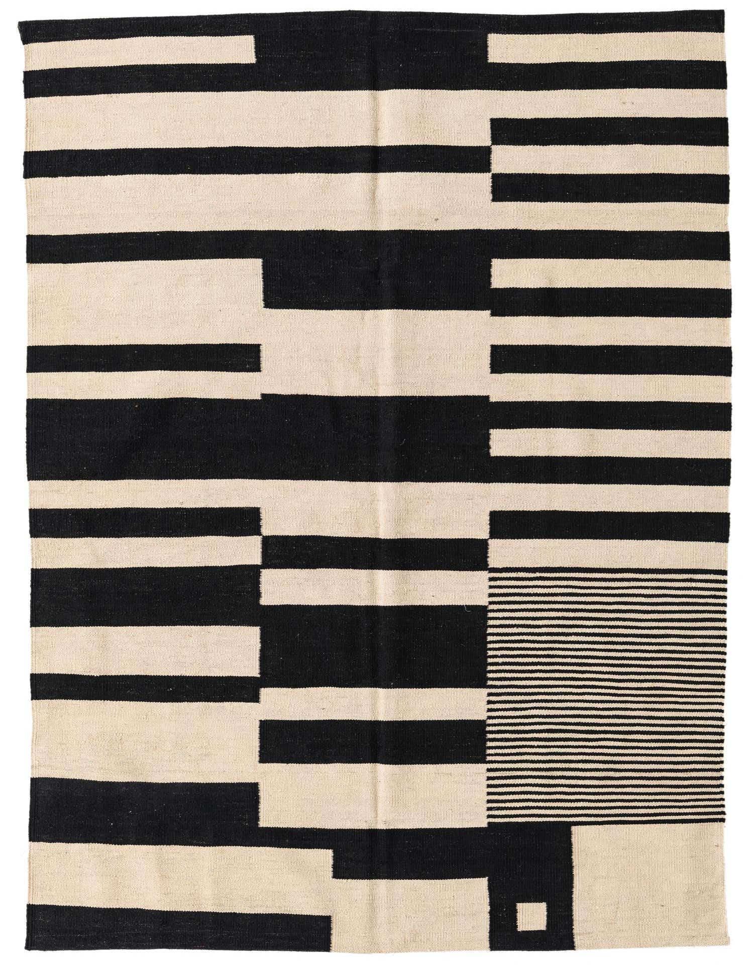A 5x8 rectangular flatweave rug featuring a bold abstract tribal pattern in black and ivory, suitable for a modern living room.