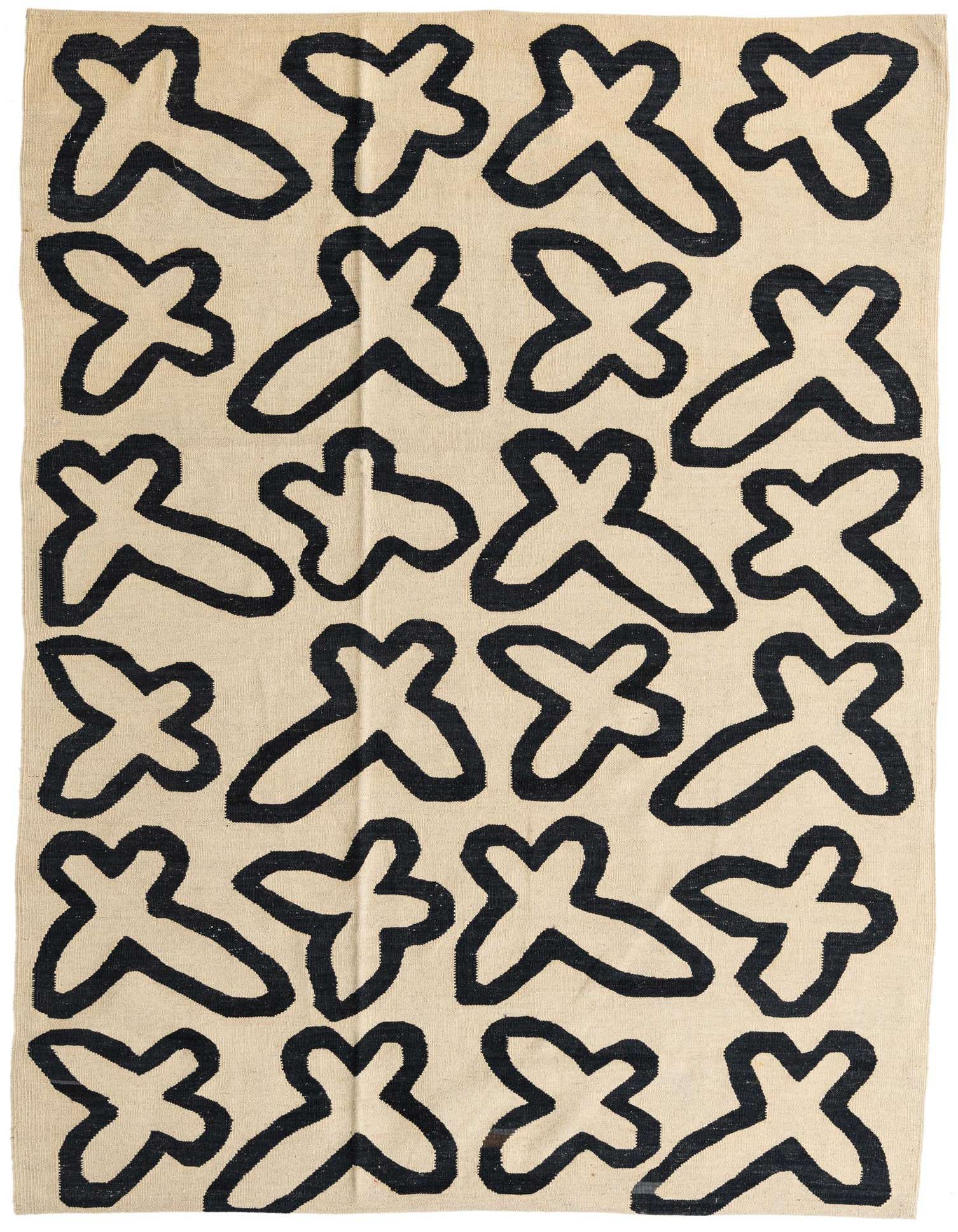 A 6x9 rectangular ivory flatweave rug with a bold, abstract black tribal pattern, suitable for a living room.