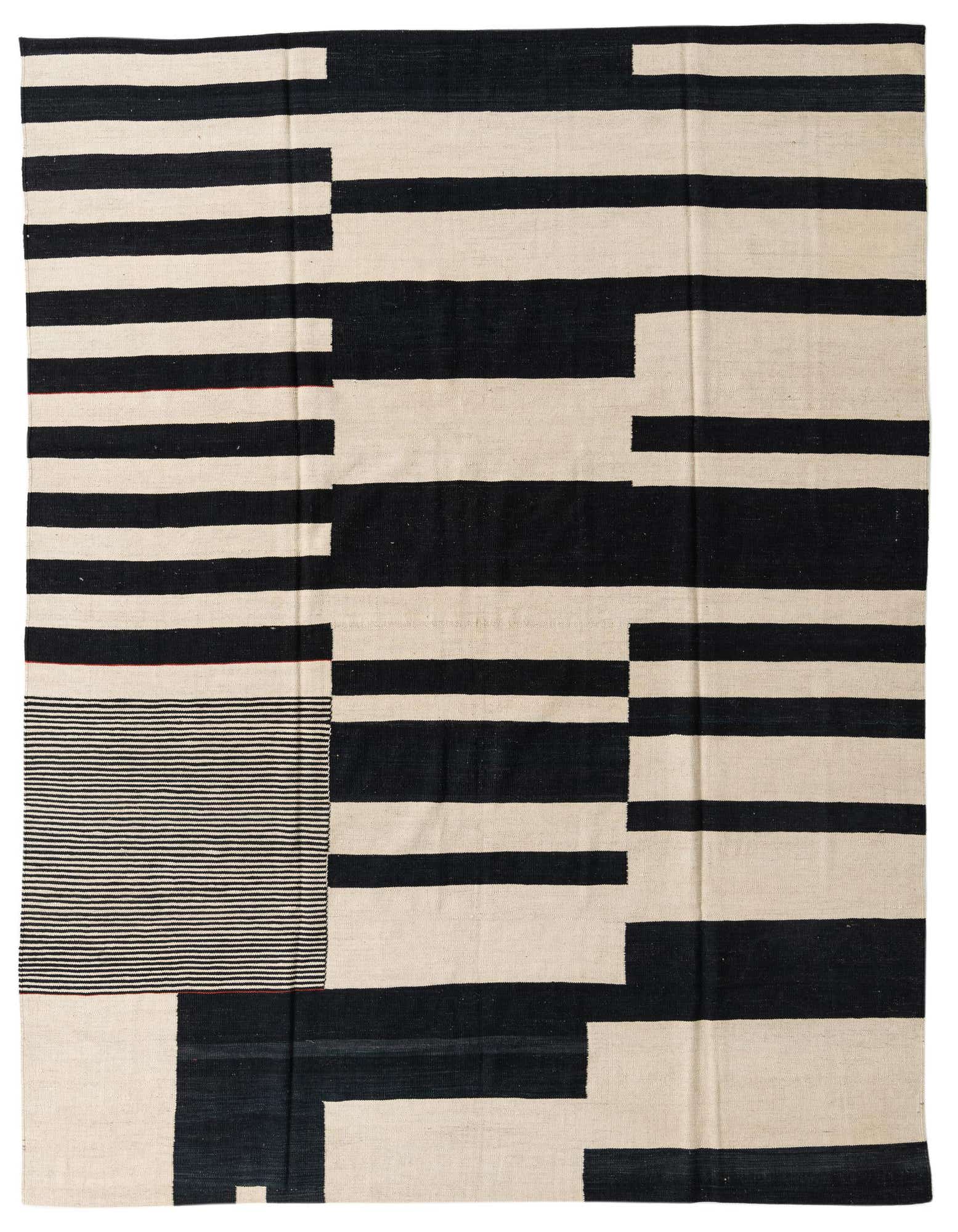 An 8x10 rectangular flatweave rug featuring a bold, modern abstract pattern of thick black and ivory stripes and blocks.