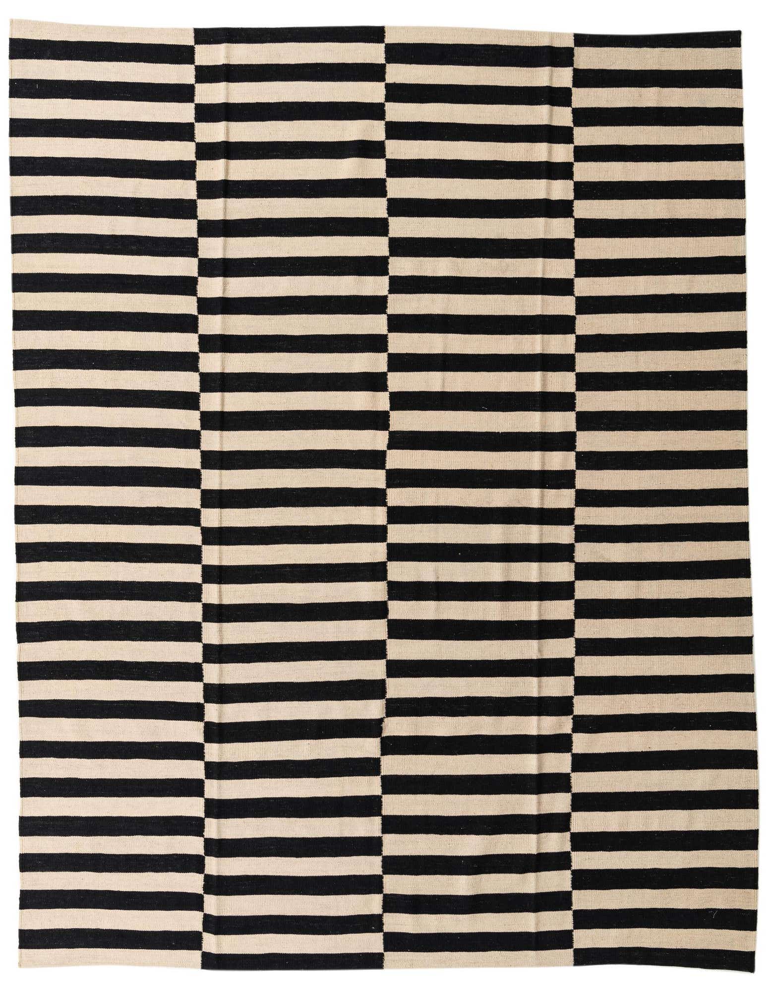 An 8x10 rectangular flatweave rug featuring a bold black and ivory striped pattern, with alternating horizontal and vertical sections.