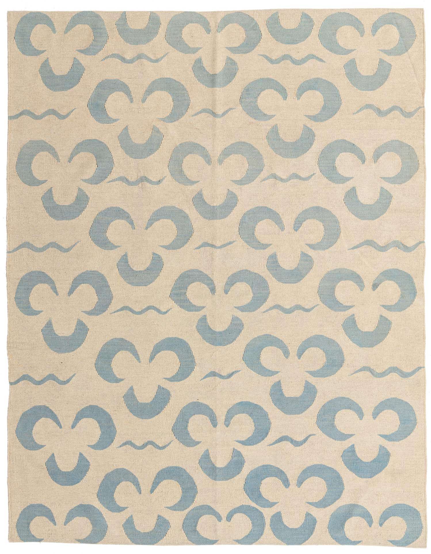 A 6x9 rectangular ivory flatweave rug with a repeating light blue tribal clover-like pattern and subtle wavy lines.