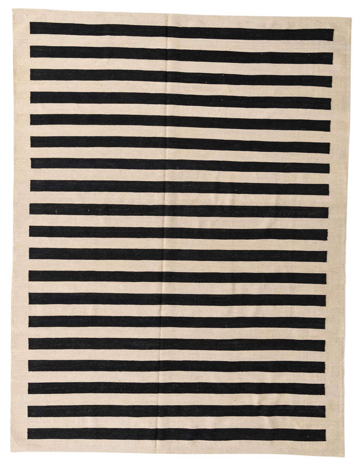 A 6x9 rectangular Rugs.com Kilim Modern flatweave rug with bold black and ivory stripes, ideal for a living room.