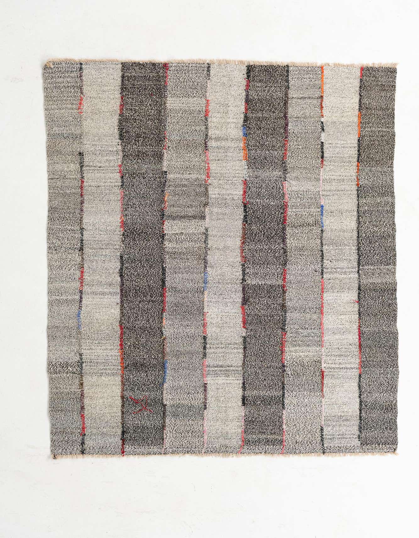 A 5x8 rectangular Kilim Modern rug with alternating light and dark gray vertical stripes, accented by thin red and blue lines, on a white background.