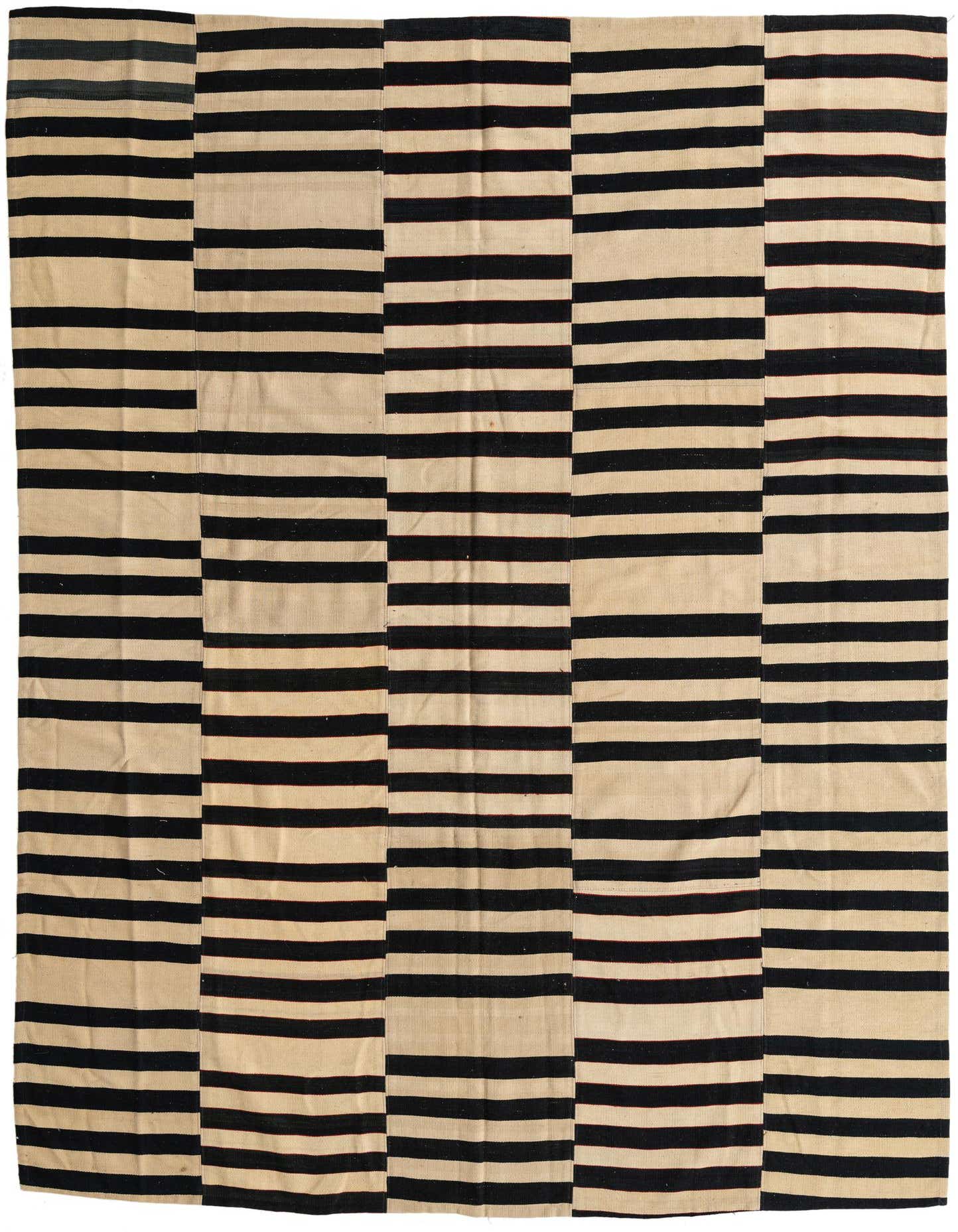 A 7x10 rectangular Kilim Modern rug with alternating horizontal stripes of black and cream, showcasing a tribal and modern aesthetic.
