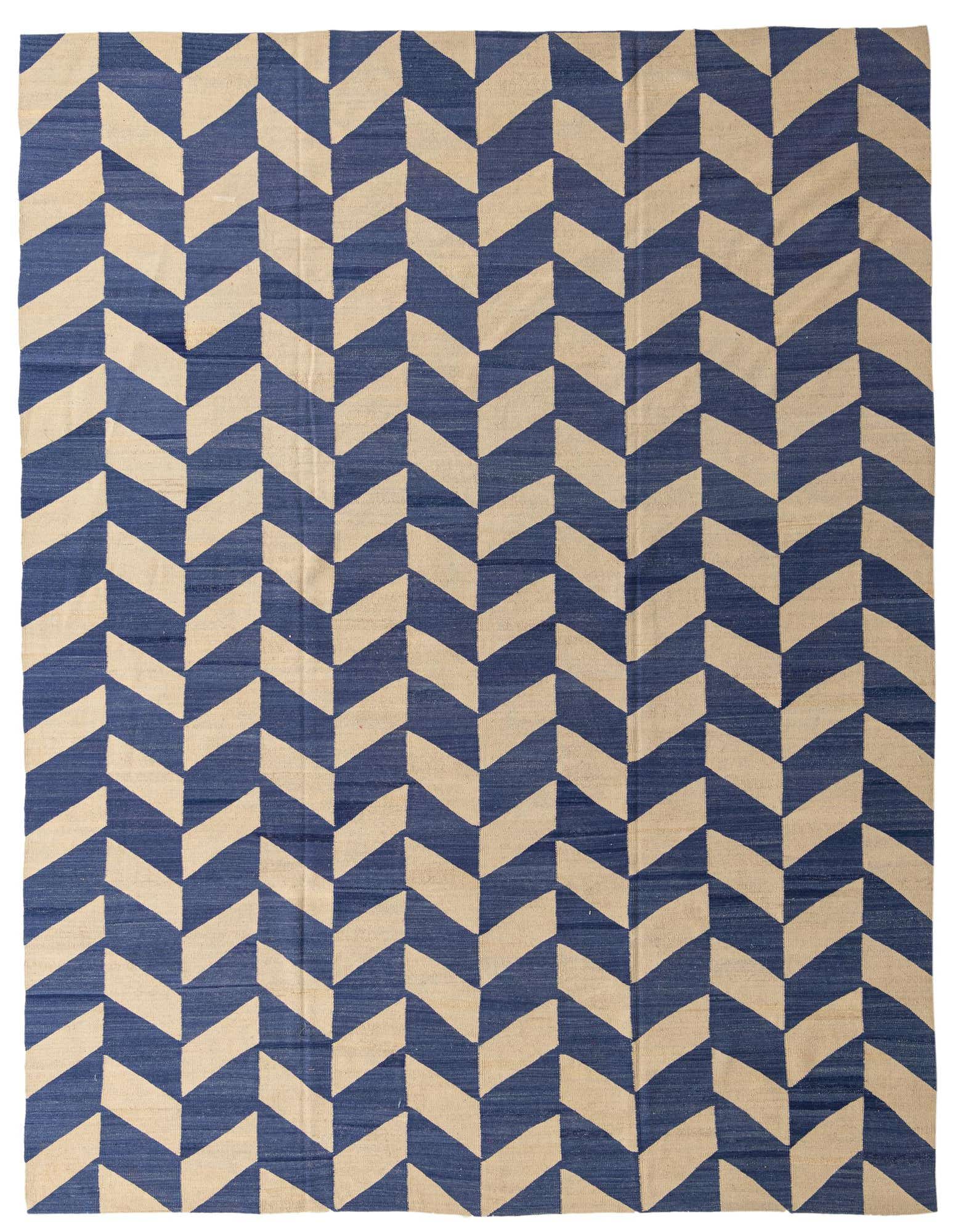 A 10x13 rectangular Kilim Modern rug with a bold chevron pattern in navy blue and cream, suitable for a living room.
