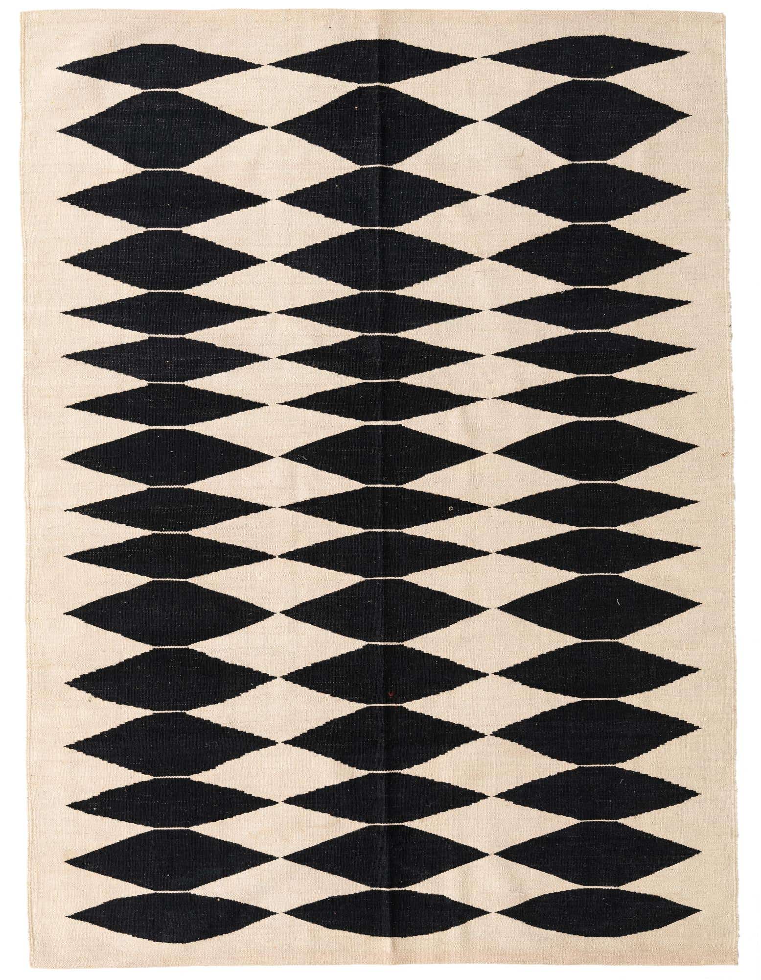 A 5x8 rectangular ivory and black flatweave wool rug with a repeating tribal diamond pattern.