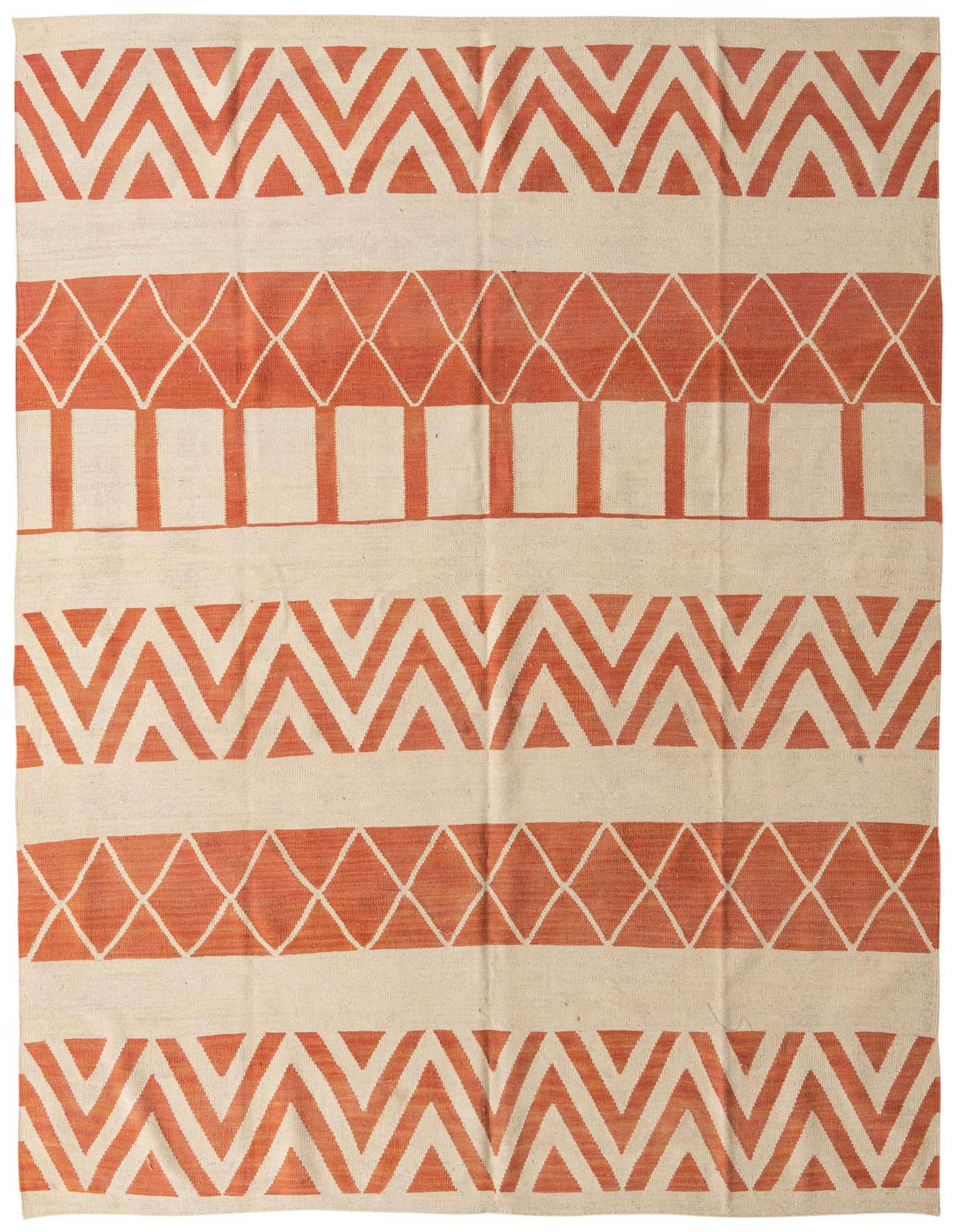 An 8x10 rectangular flatweave wool rug featuring bold tribal patterns in ivory and terracotta orange, suitable for a living room.