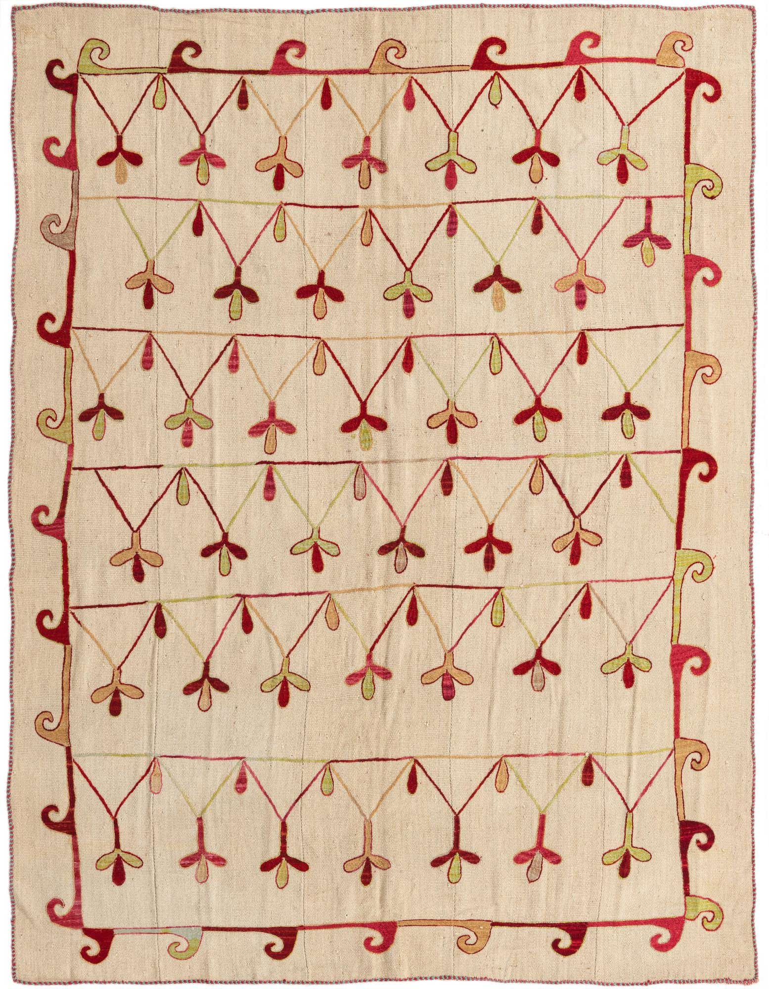 A 6x9 rectangular ivory flatweave rug with a tribal pattern of red, green, and gold abstract floral motifs.