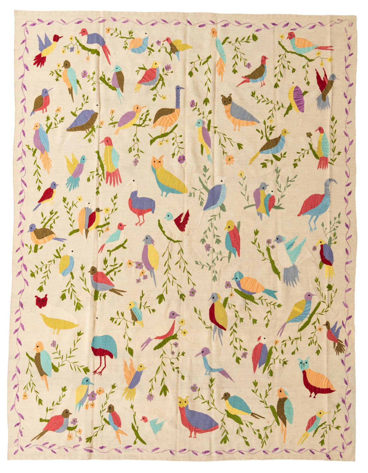 An 8x10 ivory rectangular rug with a vibrant, colorful bird and floral tribal pattern and a purple vine border.