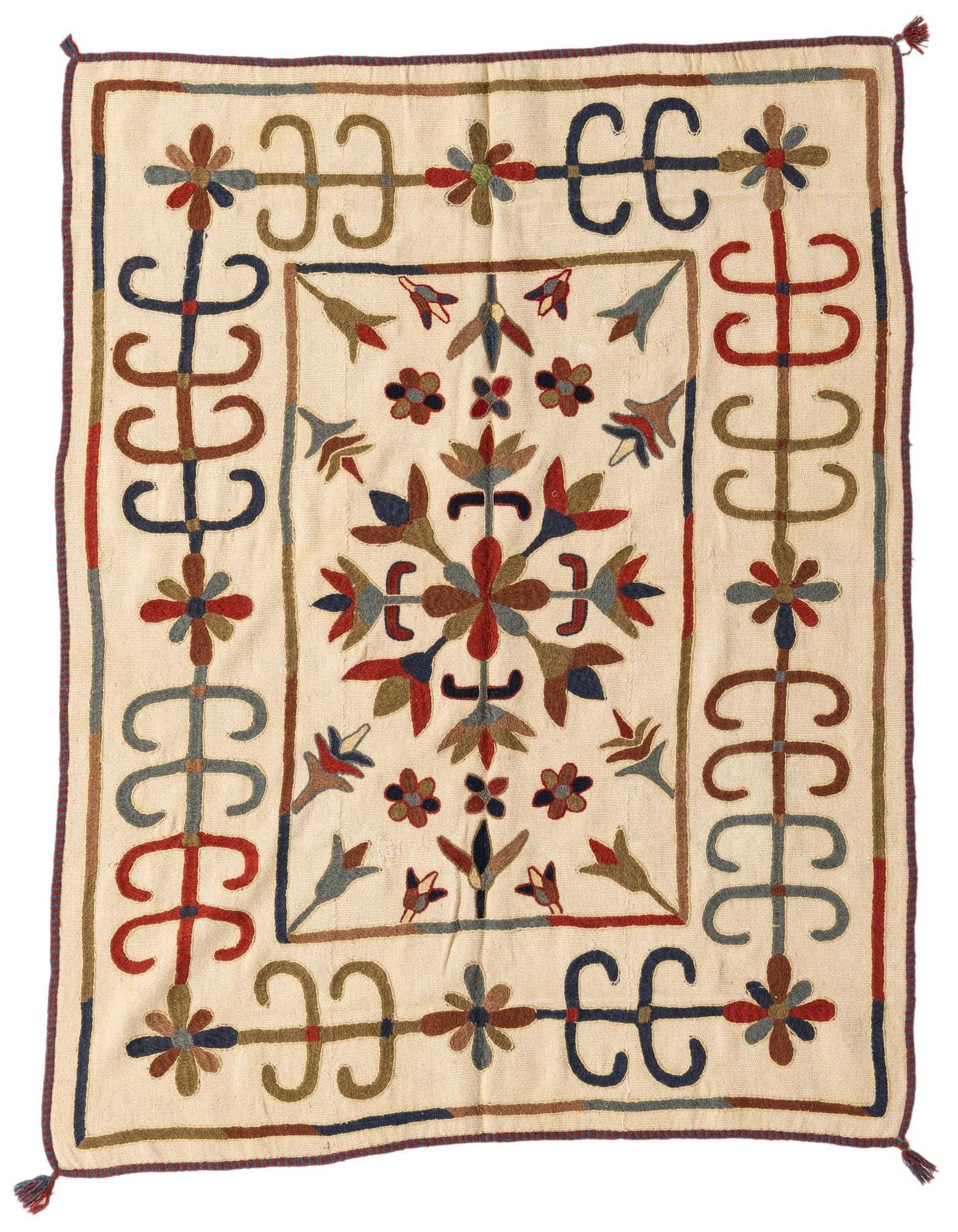 A 4x6 rectangular ivory Kilim Suzani rug with a tribal floral pattern in red, blue, and brown, featuring a central medallion and decorative border.