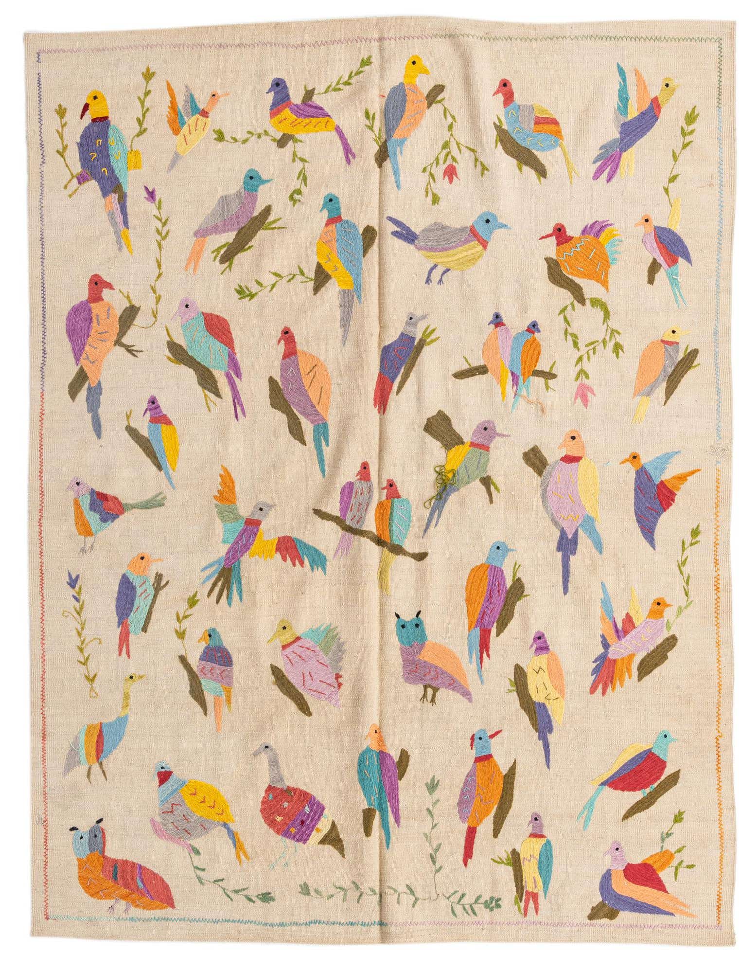 A 6x9 rectangular ivory flatweave rug featuring a vibrant, multicolored tribal bird and branch pattern.