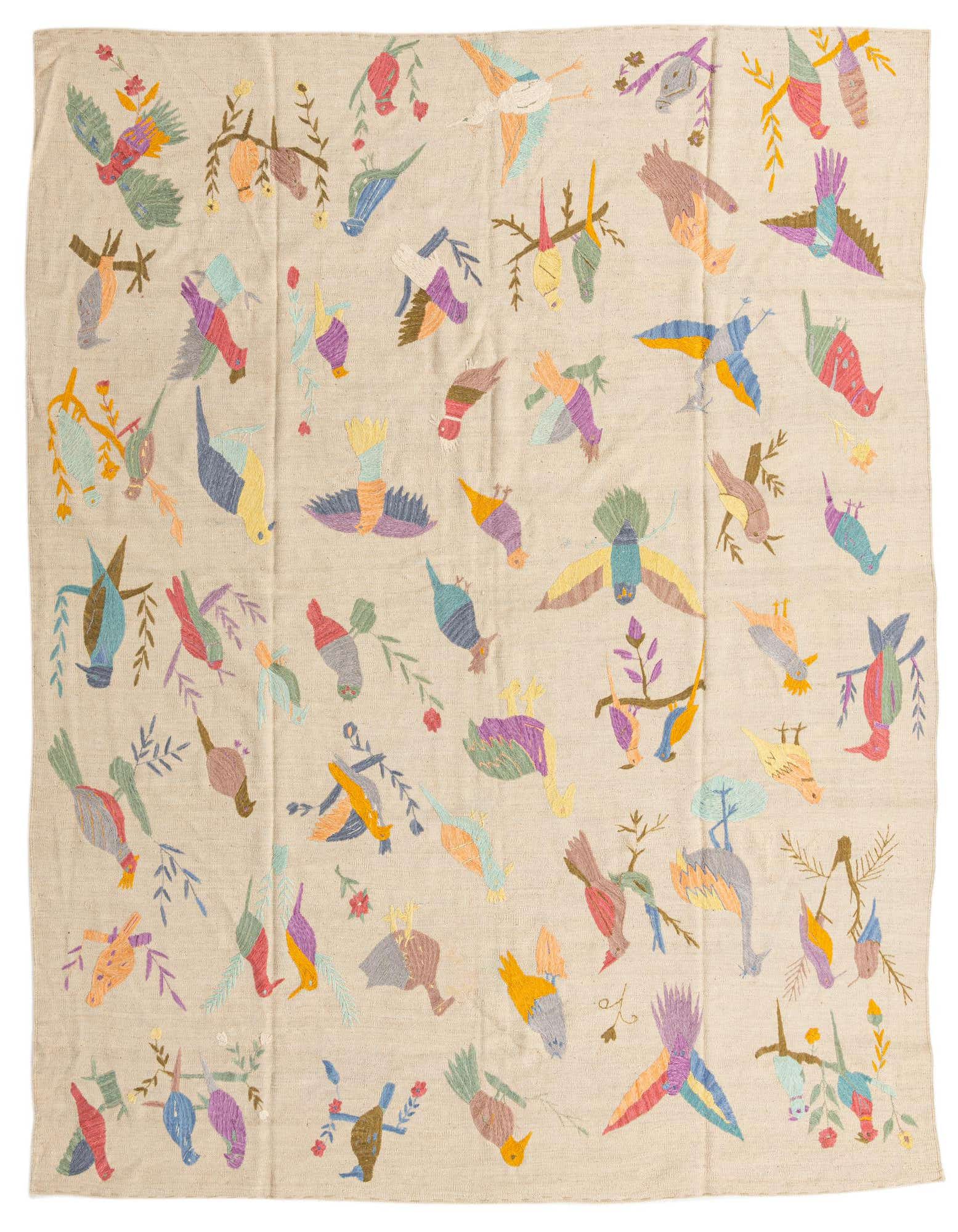An 8x10 ivory flatweave rug featuring a vibrant, multicolored tribal bird and floral pattern, ideal for a living room.