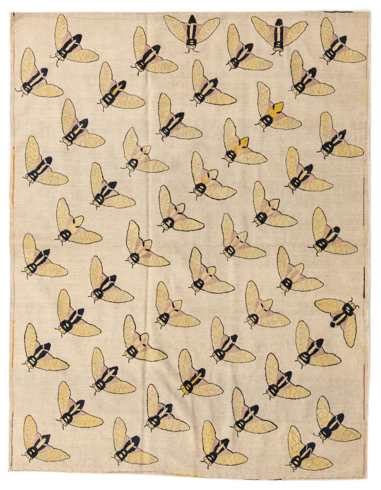 A 5x8 rectangular ivory flatweave rug with a repeating pattern of yellow and black tribal moth-like insects.