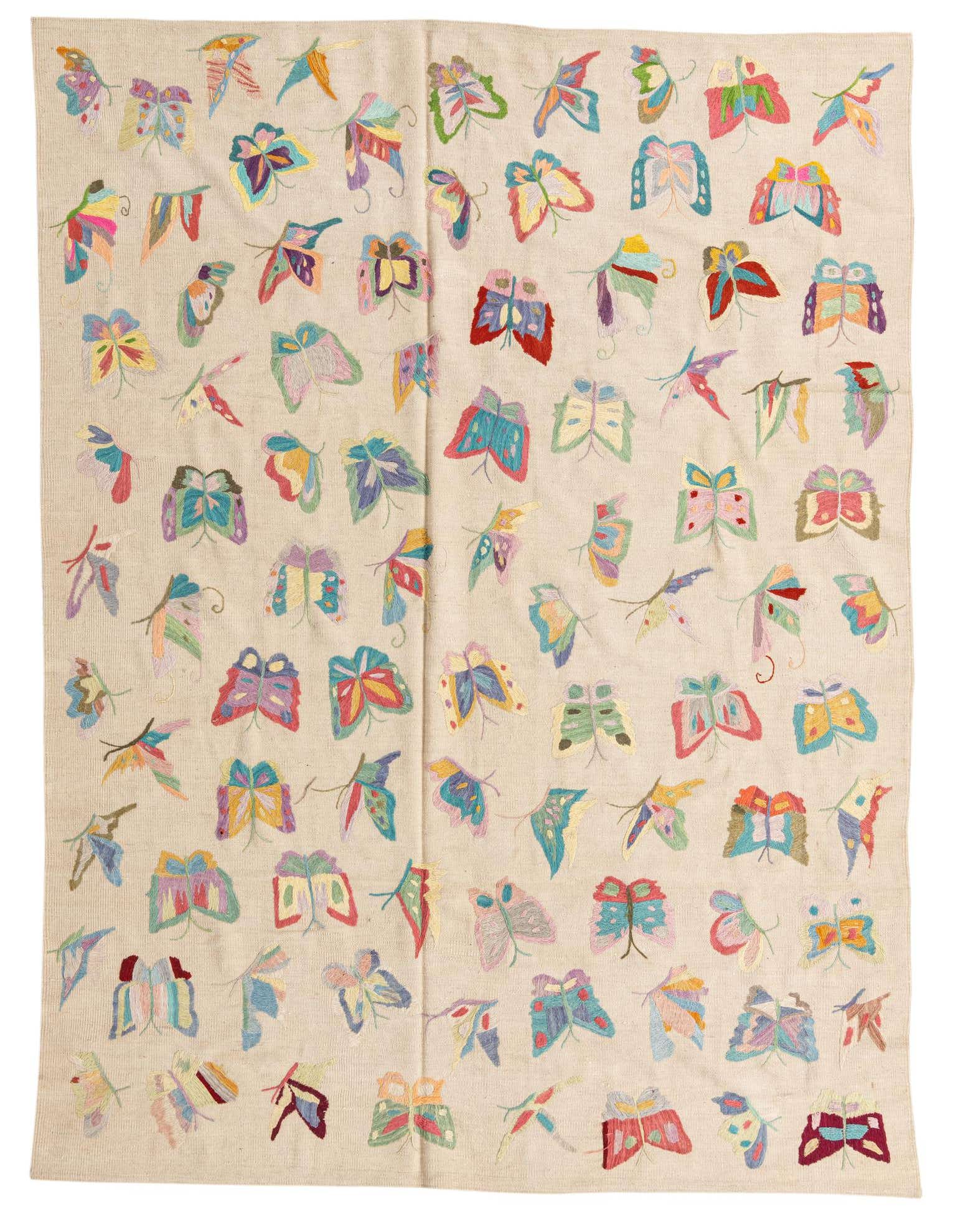 A 6x9 rectangular ivory wool flatweave rug with a vibrant, multicolored butterfly pattern, suitable for a living room.