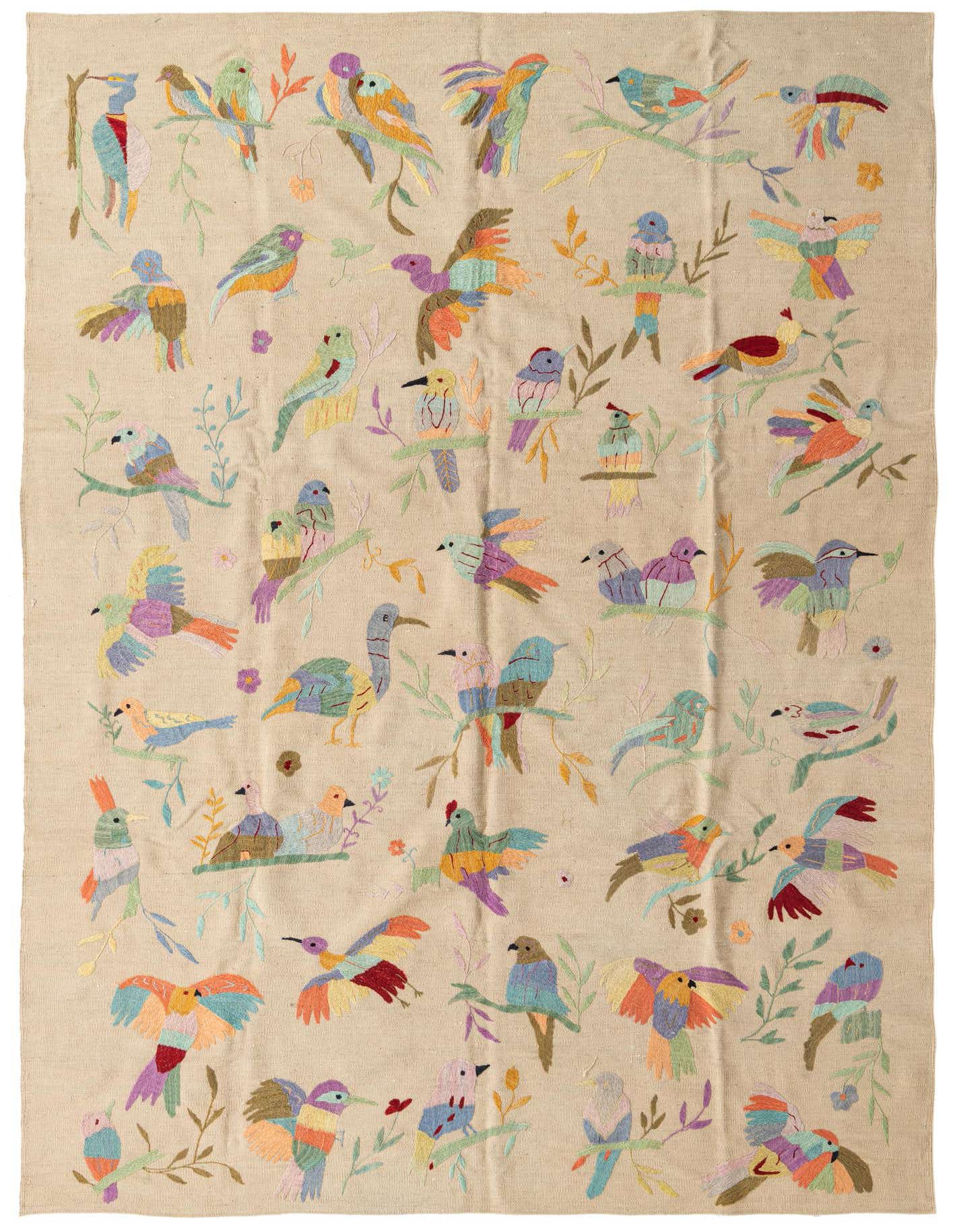 A 6x9 rectangular ivory flatweave rug featuring a vibrant, multicolored tribal bird and floral pattern.