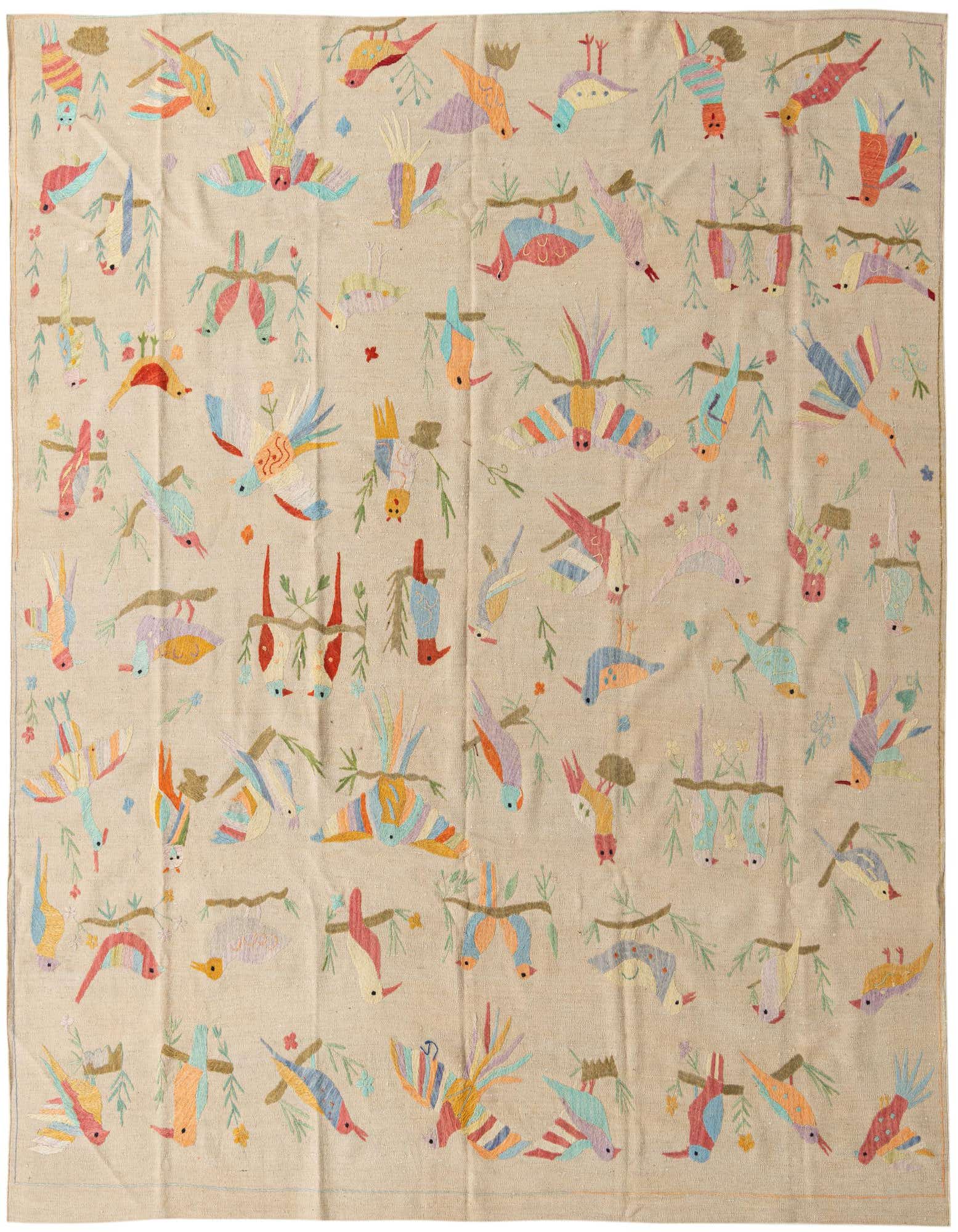 An 8x10 ivory flatweave rug features a vibrant, colorful tribal pattern of birds and branches.