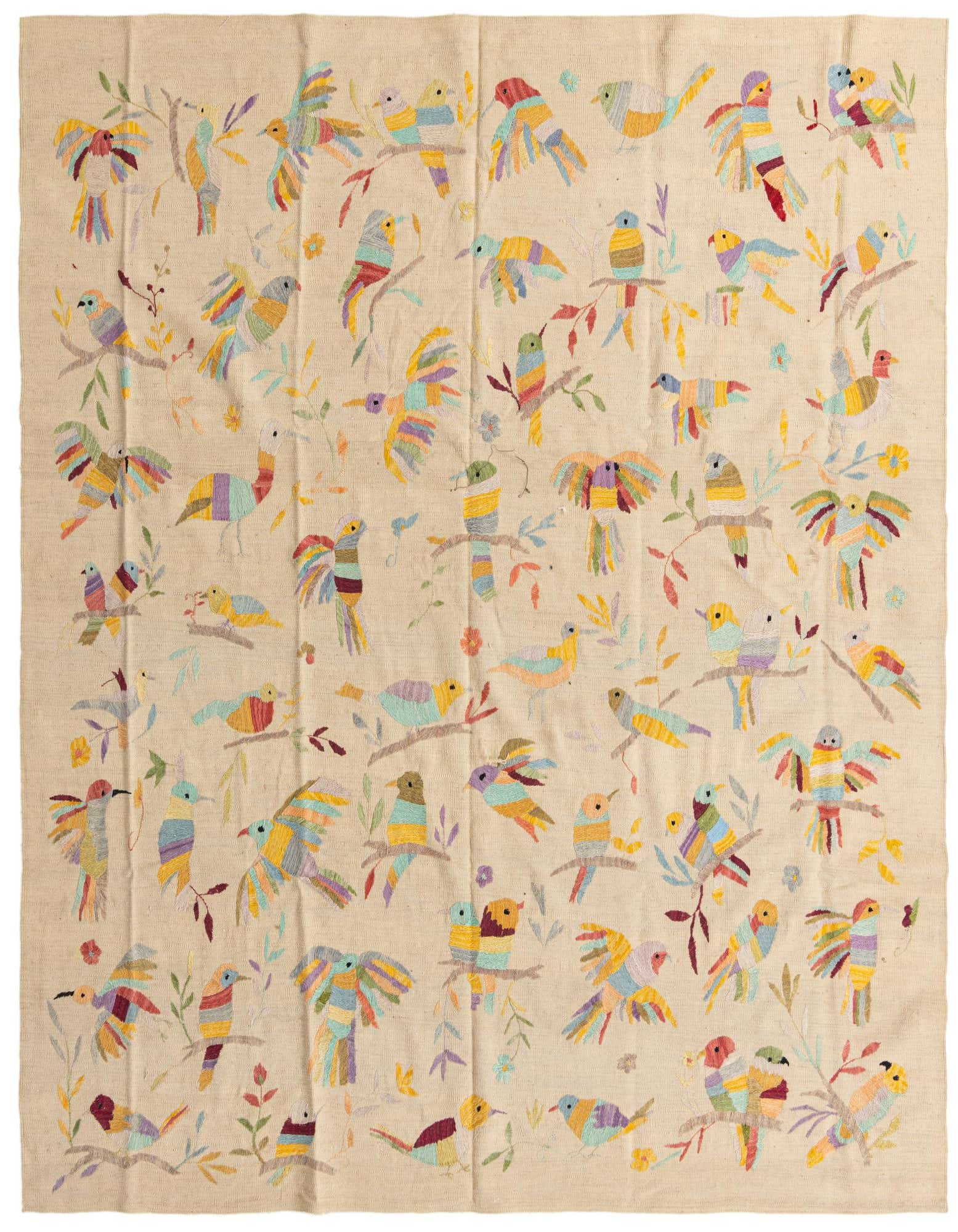 An 8x10 rectangular ivory flatweave rug featuring a vibrant, colorful tribal pattern of birds and branches.
