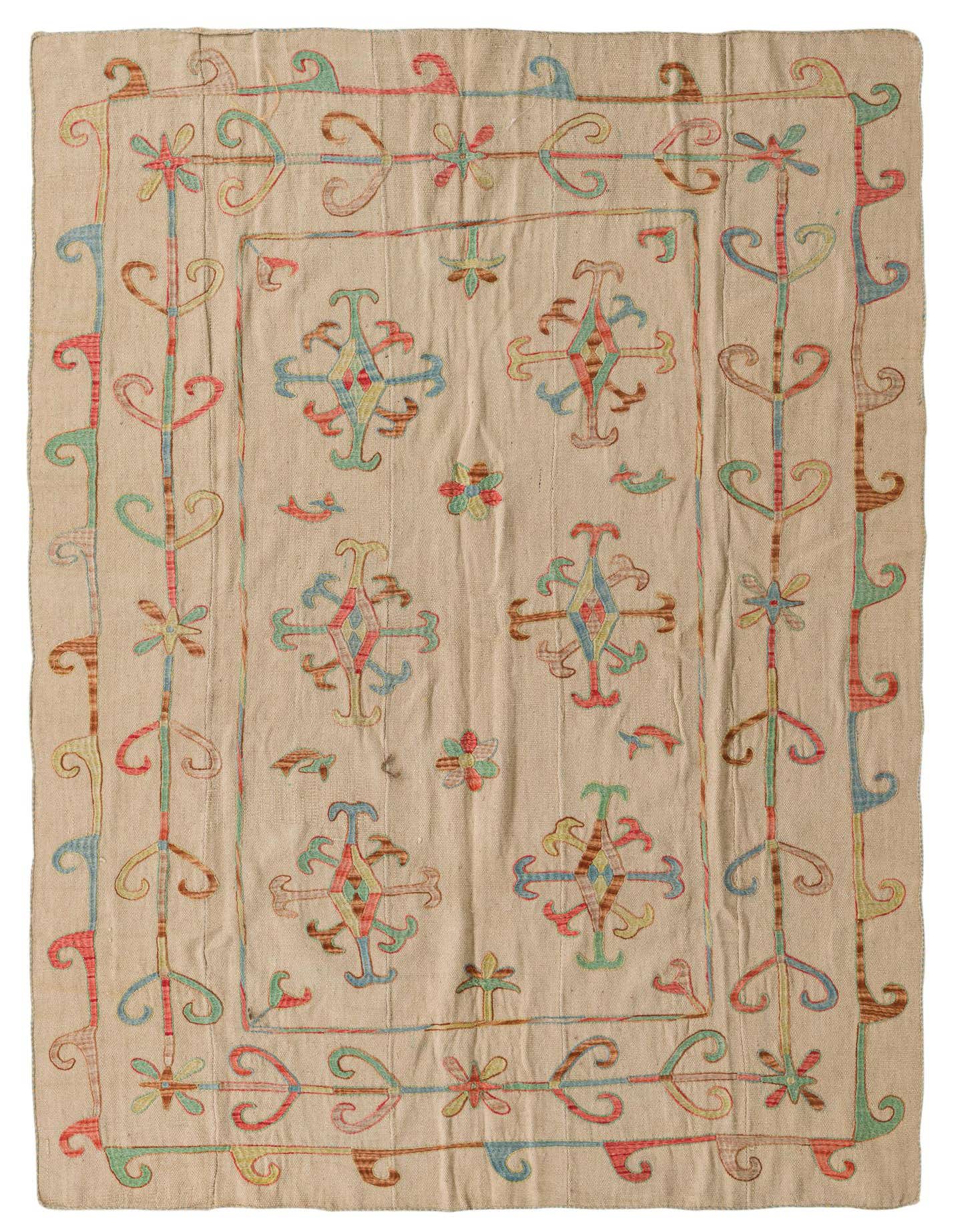 A 5x8 rectangular ivory flatweave rug with a colorful tribal Suzani pattern in red, blue, green, and brown.