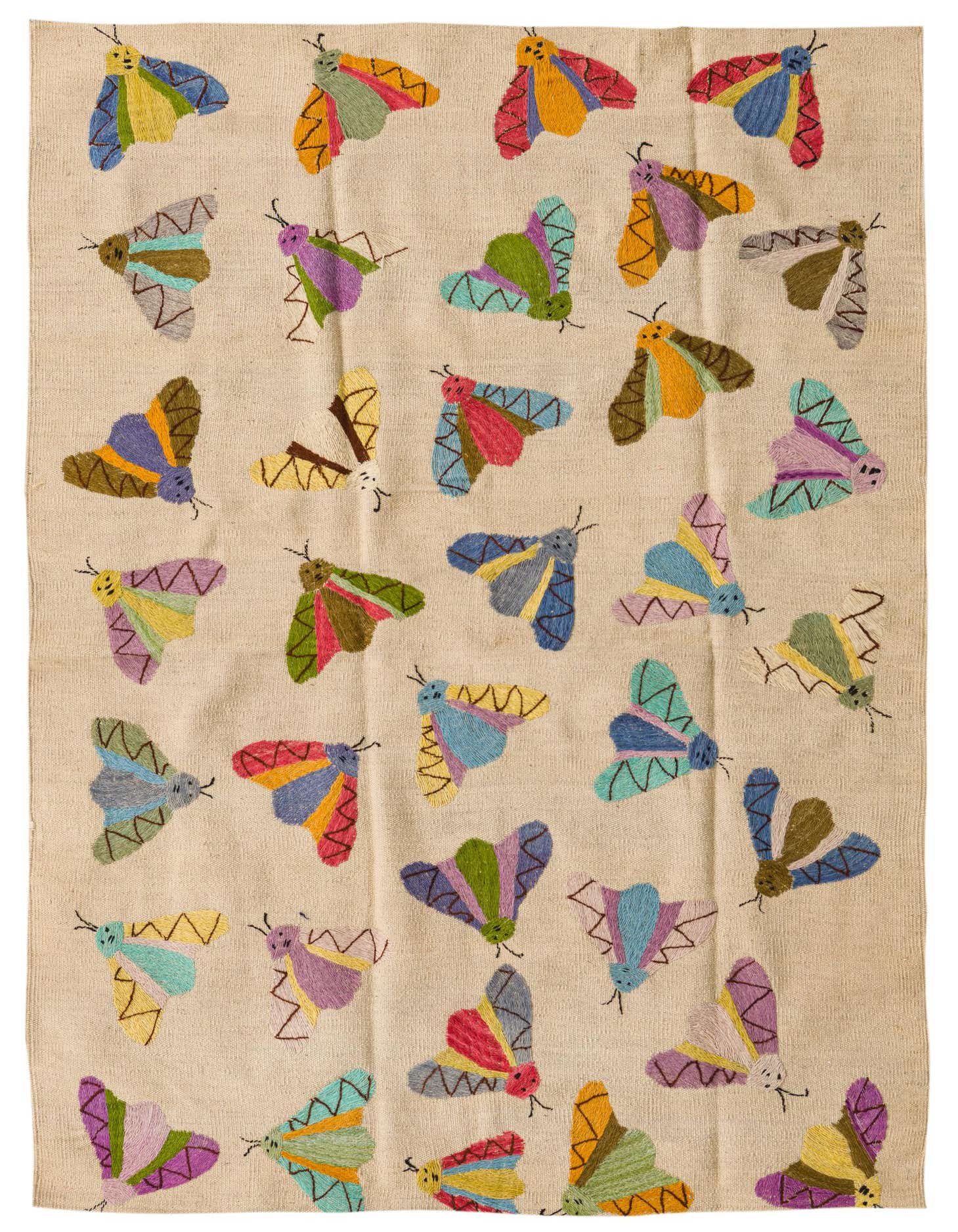 A 4x6 ivory flatweave rug with a colorful, scattered pattern of embroidered moths in various bright hues like blue, pink, yellow, and green.