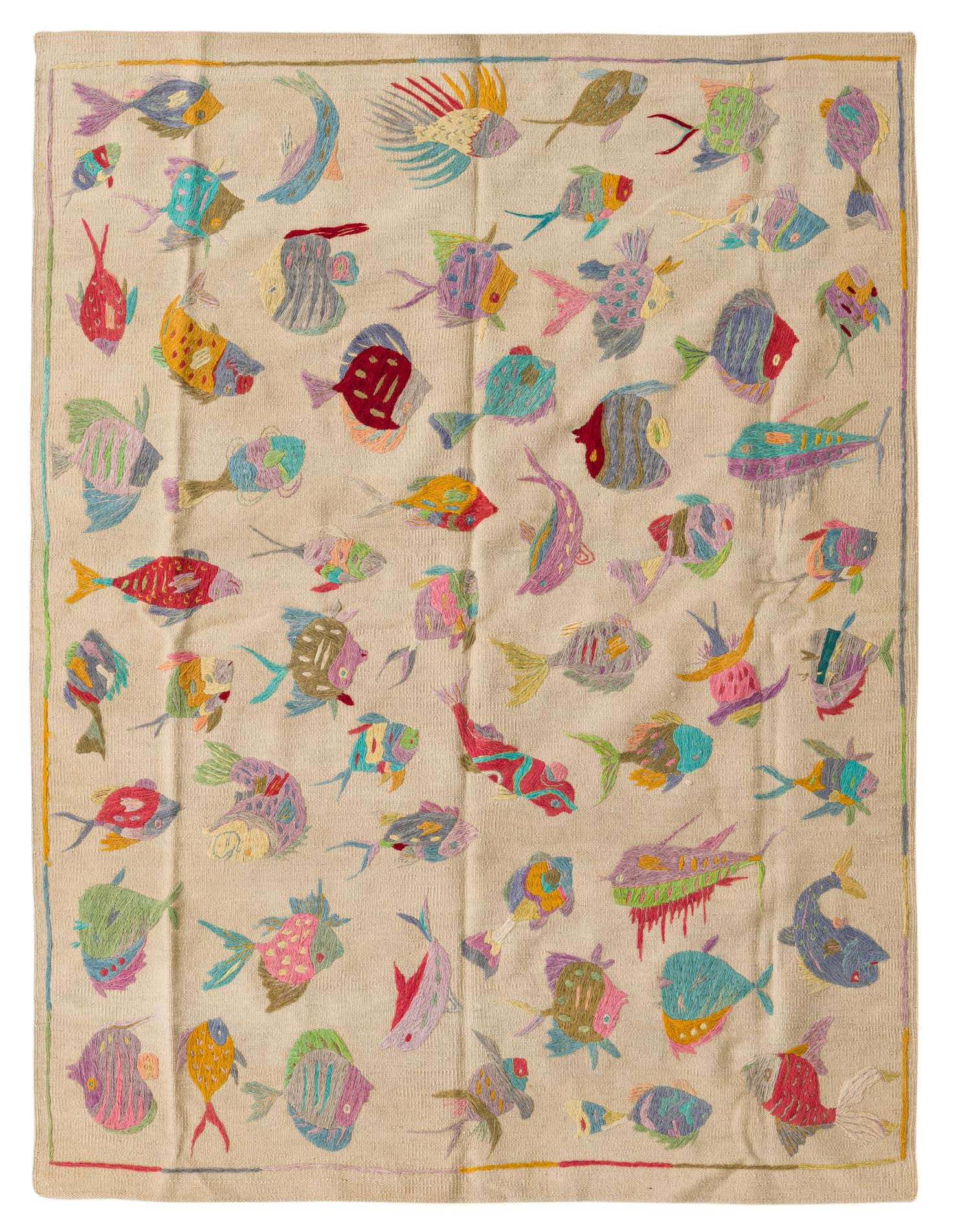 A 4x6 rectangular ivory flatweave rug featuring a vibrant, multicolored tribal fish pattern, ideal for a living room.
