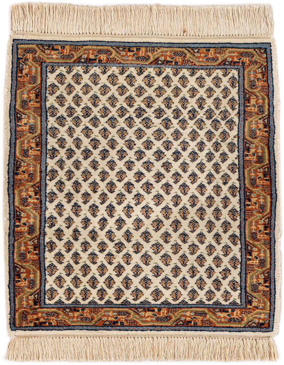 A 2x3 rectangular ivory wool rug with a traditional Oriental pattern, featuring a central field of small repeating motifs and a detailed rust-colored border with blue accents.