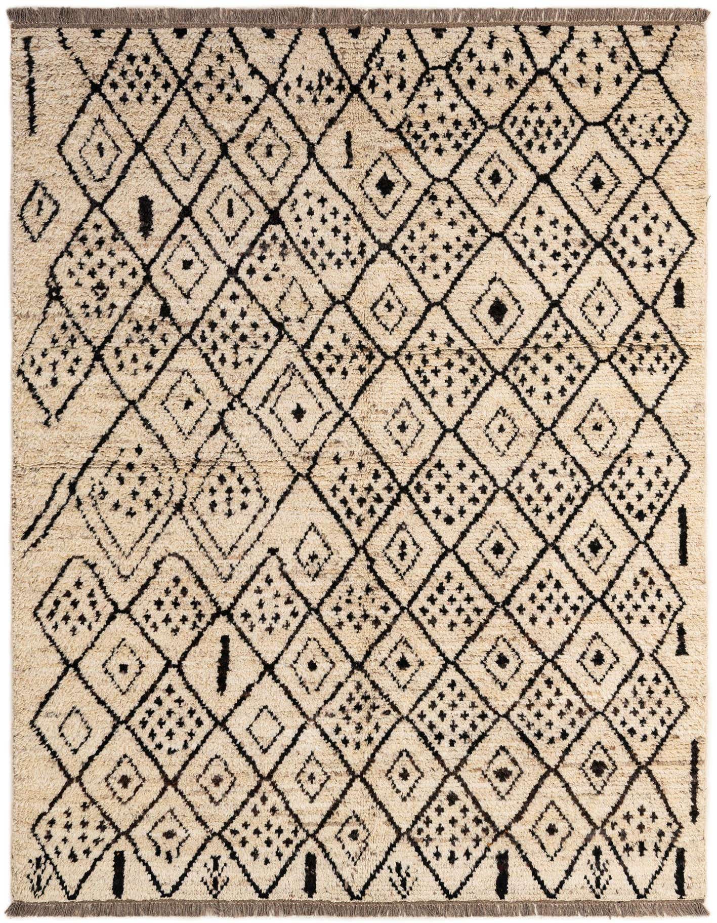 A 5x7 rectangular ivory shag rug with a black tribal diamond pattern, featuring long, soft wool fibers.