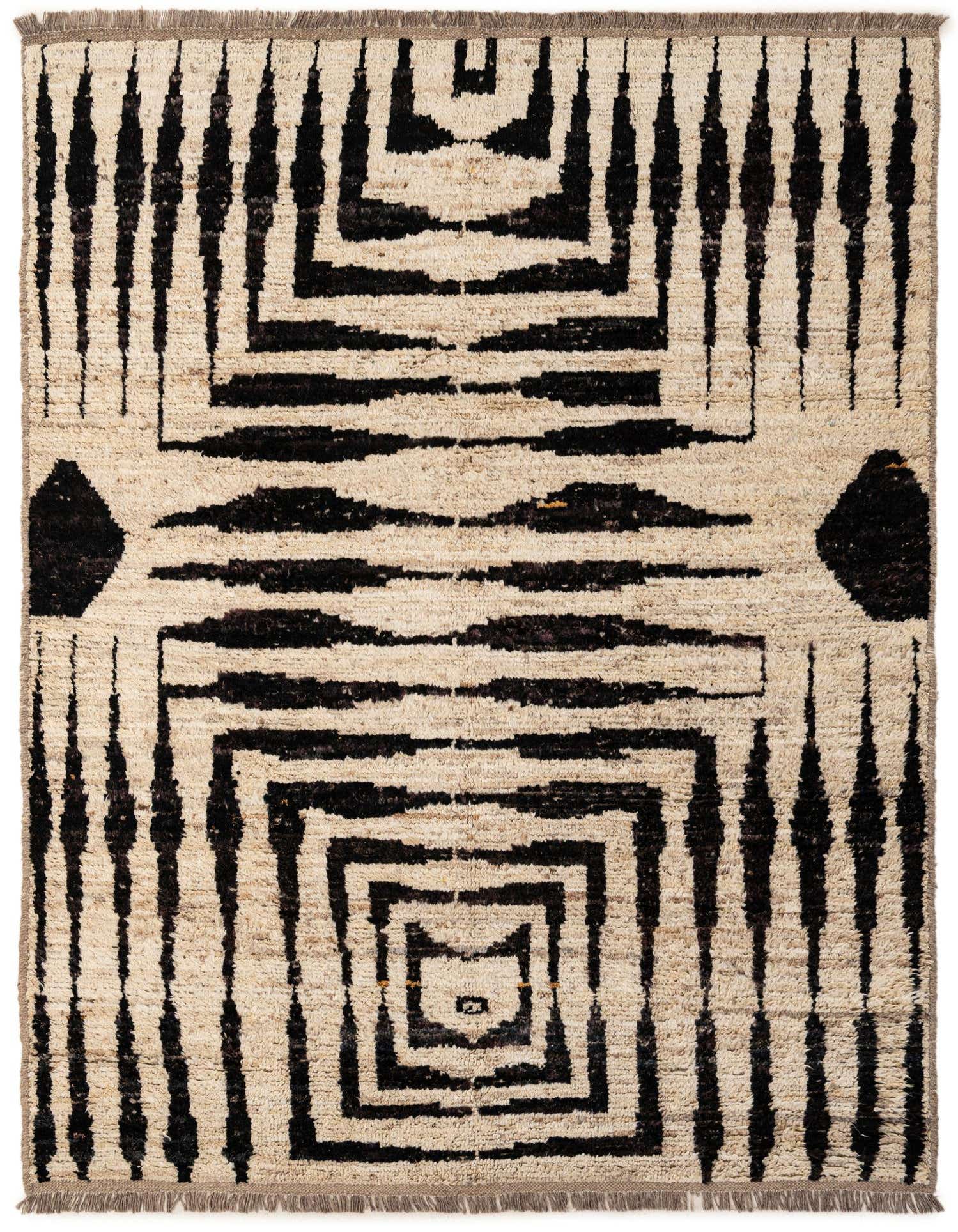 A 5x8 rectangular ivory wool rug with a bold black tribal geometric pattern, featuring squares and vertical lines.