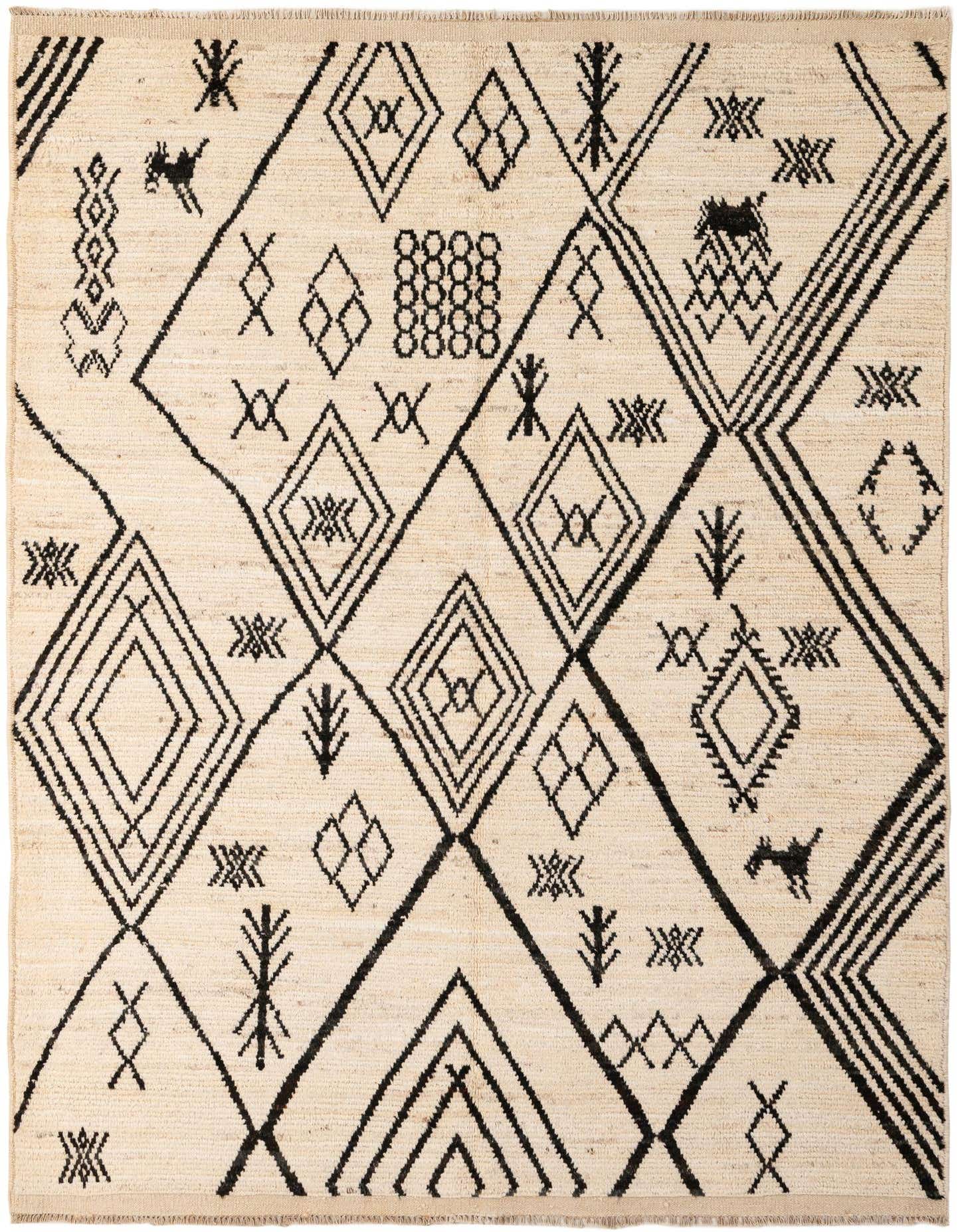 A 5x8 rectangular ivory wool shag rug with a bold black tribal geometric pattern, suitable for a living room.