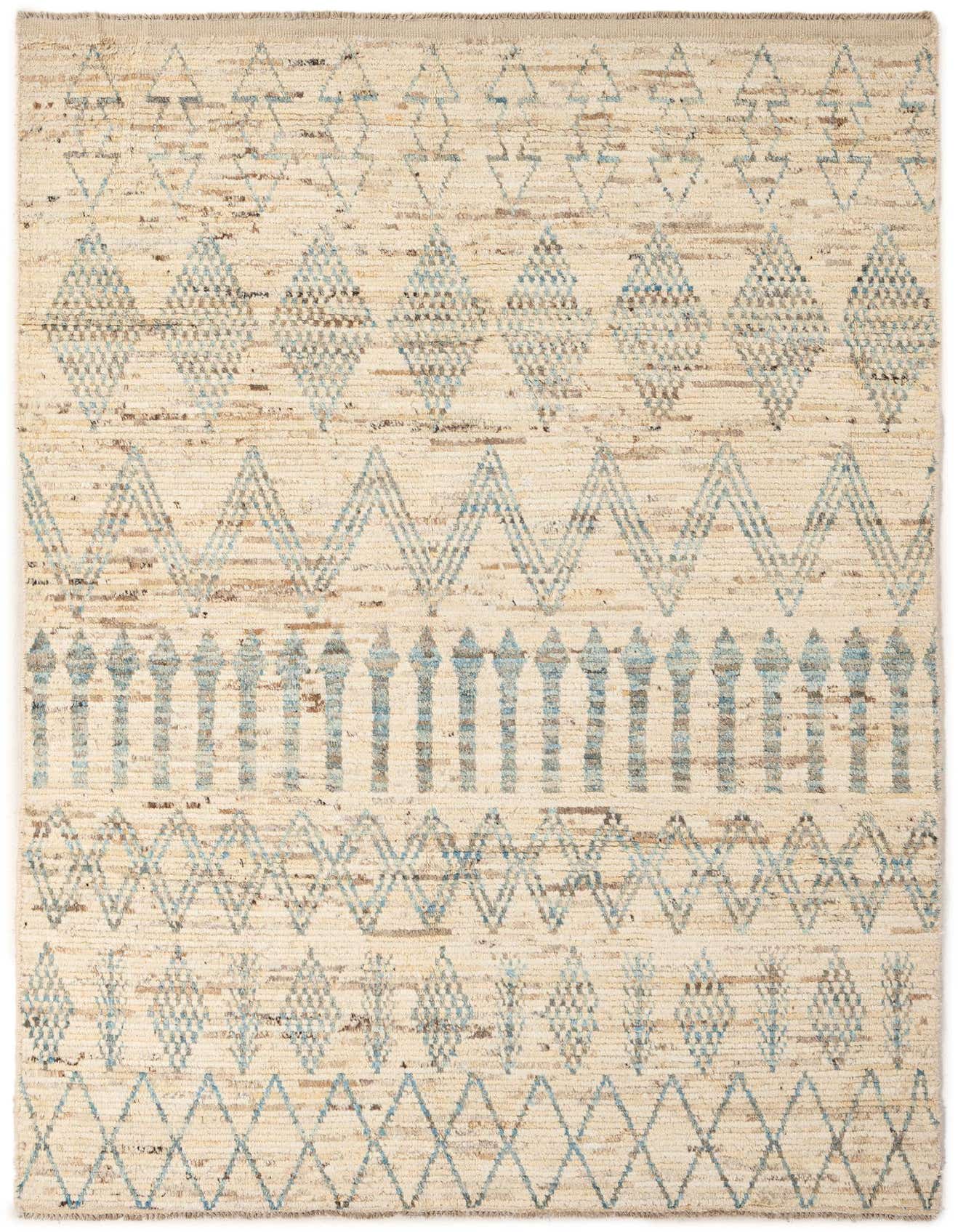 A 6x9 rectangular ivory wool rug with a tribal pattern of blue and brown geometric shapes.