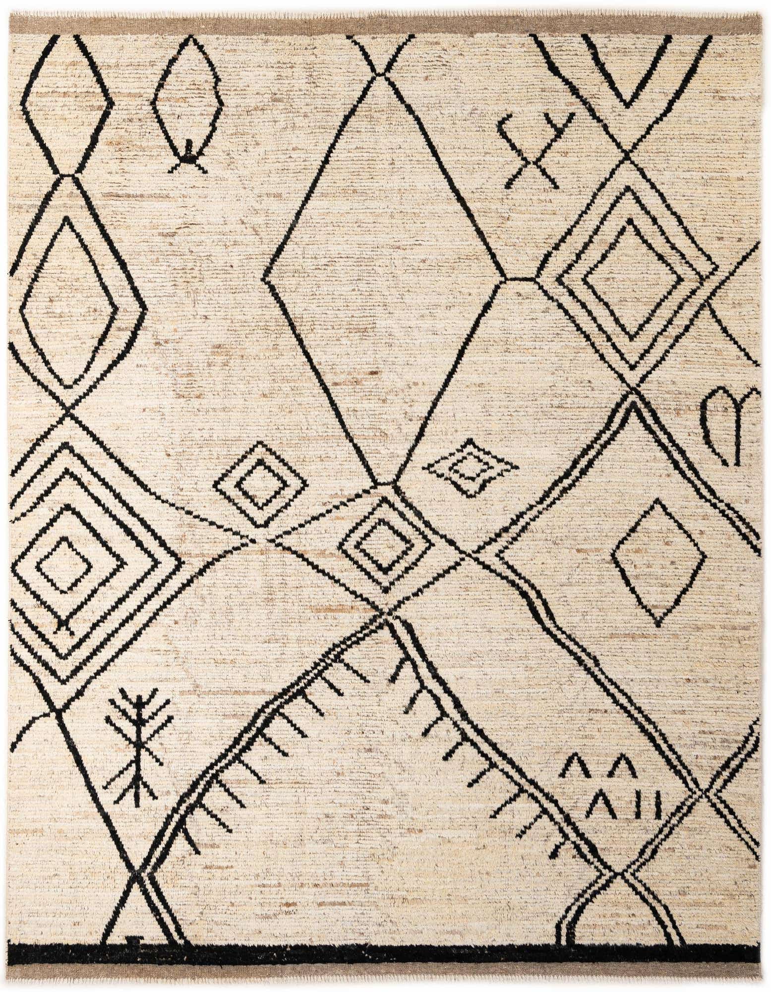 A rectangular 8x10 ivory shag rug with a bold black tribal geometric pattern, suitable for a living room.