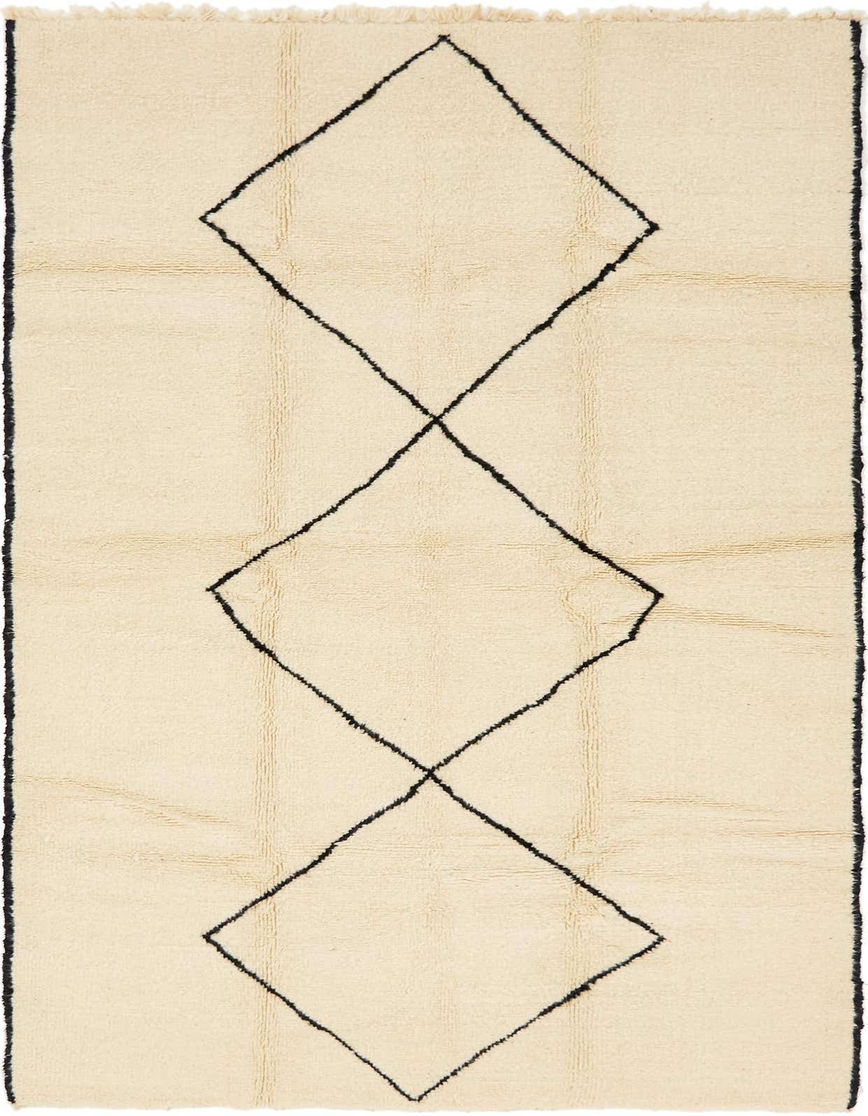 A 6x9 rectangular ivory shag rug with a bold black tribal diamond pattern, ideal for a living room.