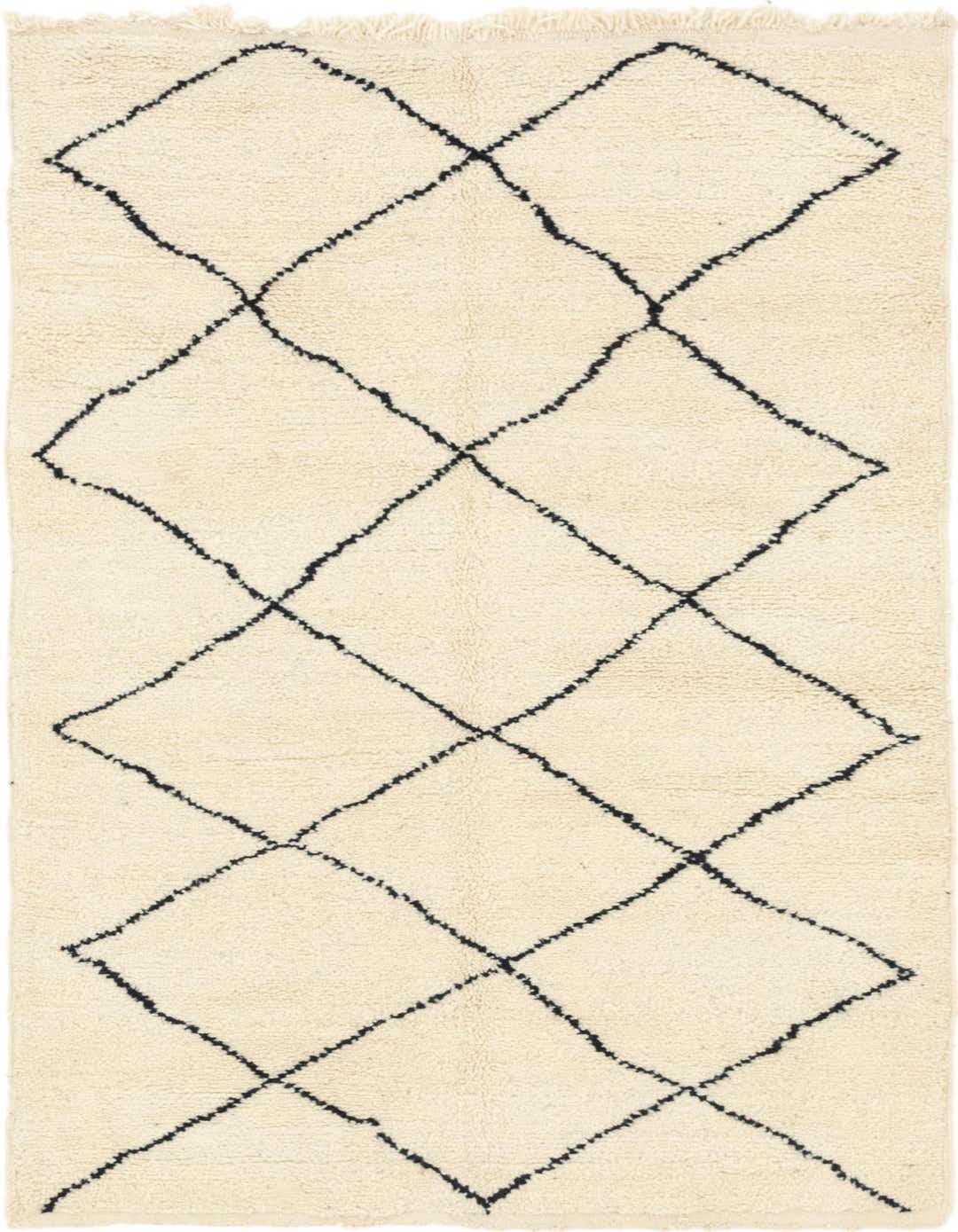 A 5x8 rectangular ivory shag rug with a black tribal diamond pattern, ideal for a living room or bedroom.