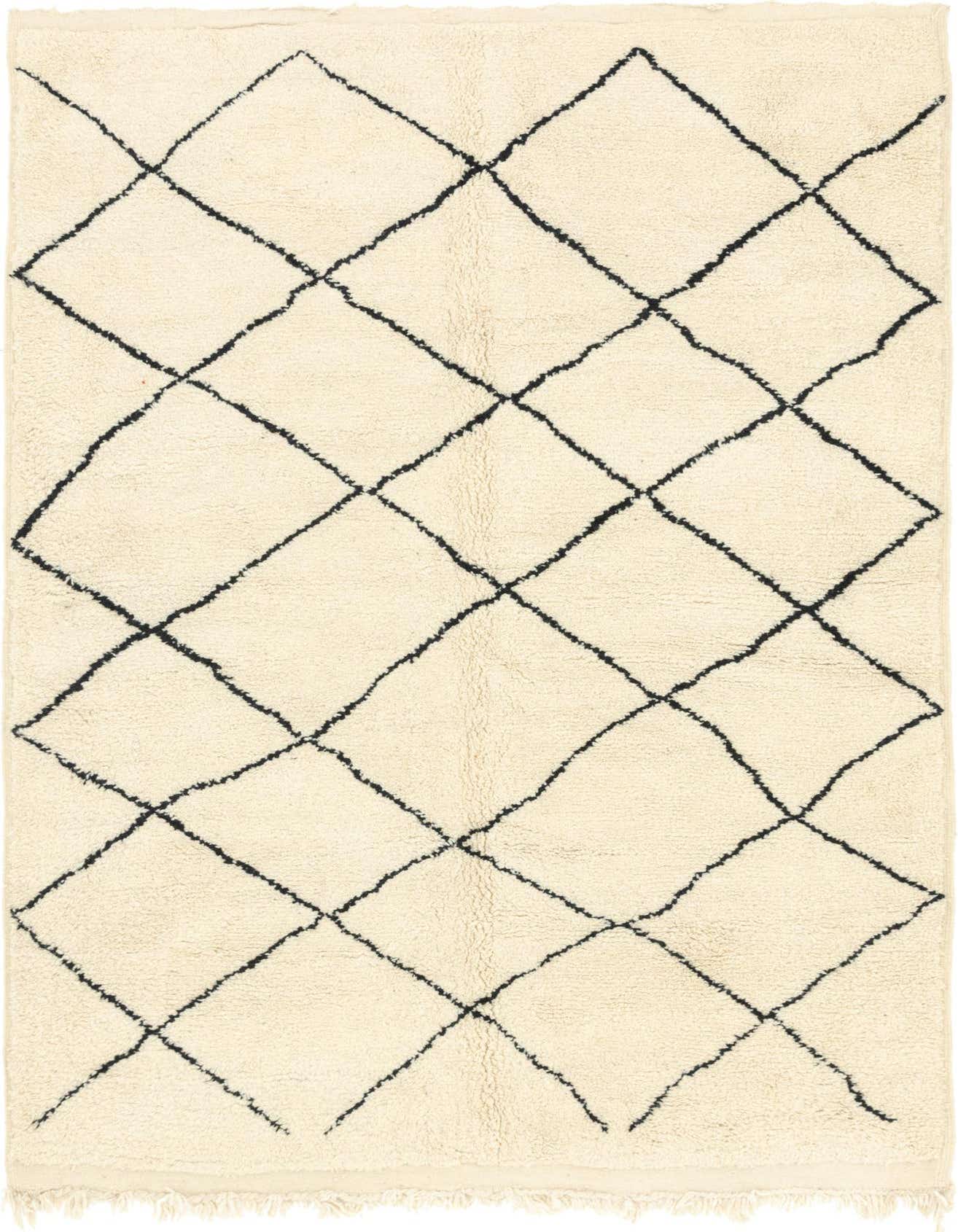 A 7x10 rectangular ivory shag rug with a black tribal diamond pattern, ideal for a living room.