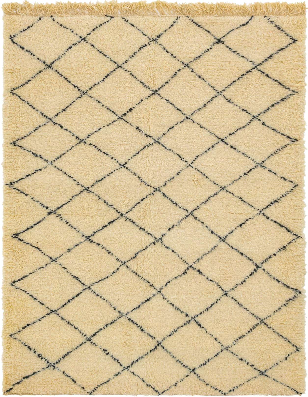 A rectangular 5x8 ivory shag wool rug with a black tribal diamond pattern and fringed edges.