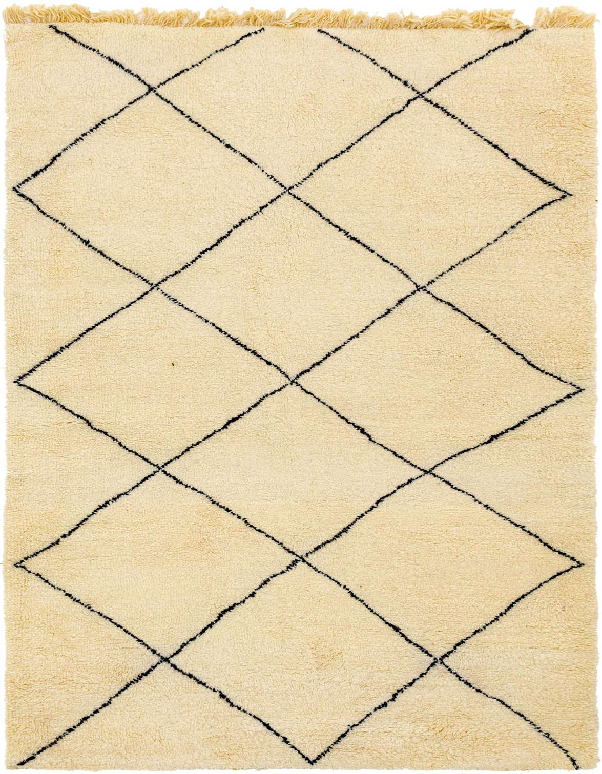A 6x9 rectangular ivory shag rug with a black tribal diamond pattern and fringe, perfect for a living room.