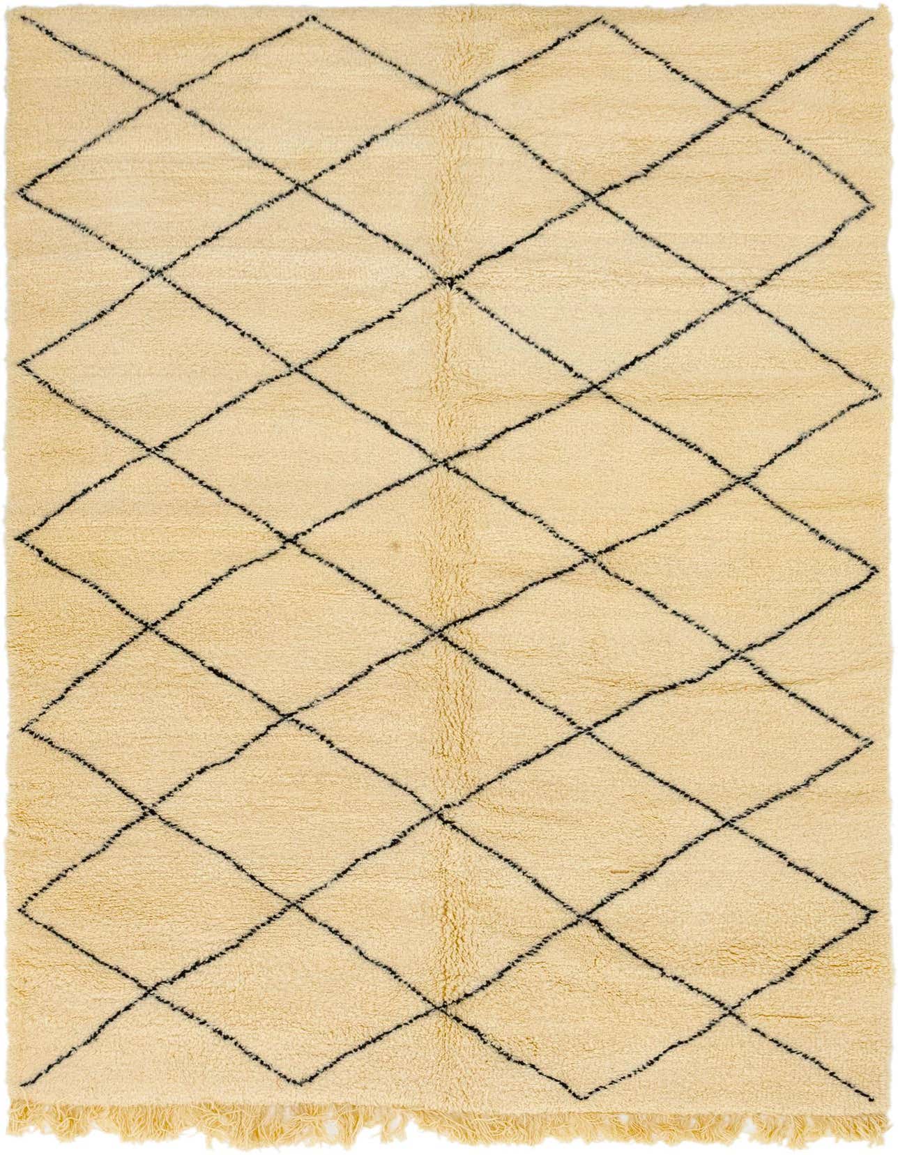 A 6x9 rectangular ivory shag rug with a black tribal diamond pattern and fringe, suitable for a living room.