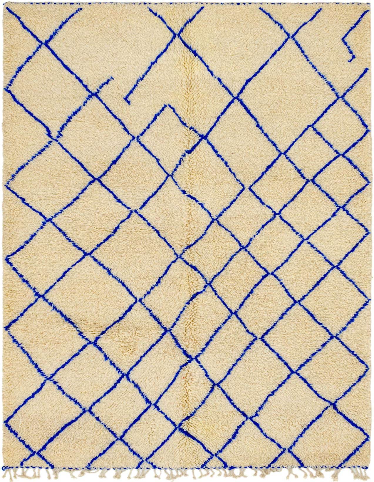 A 5x7 rectangular ivory shag rug with a bold, irregular blue diamond tribal pattern, suitable for a living room.