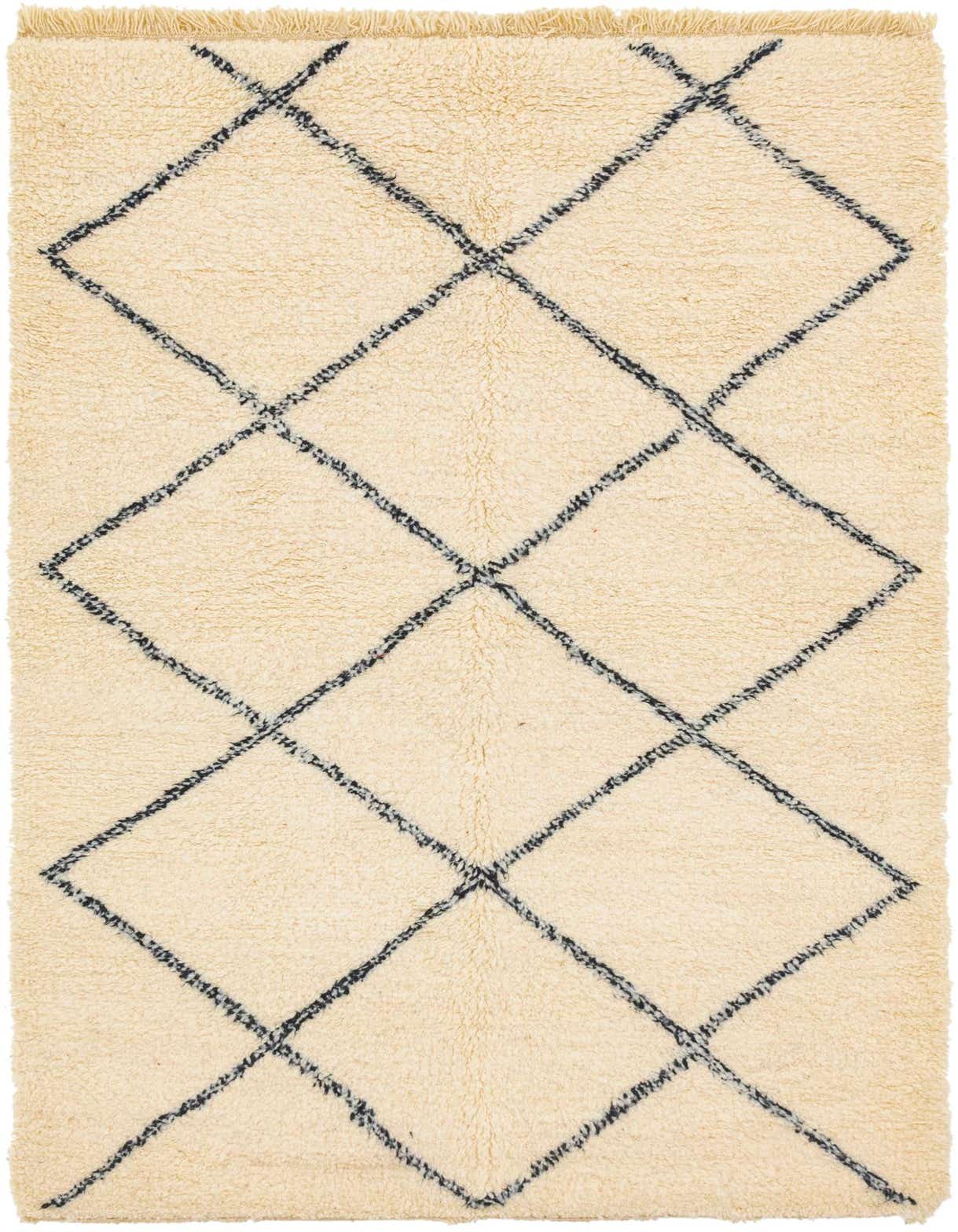 A 5x8 rectangular ivory shag rug with a black tribal diamond pattern, ideal for a living room or bedroom.