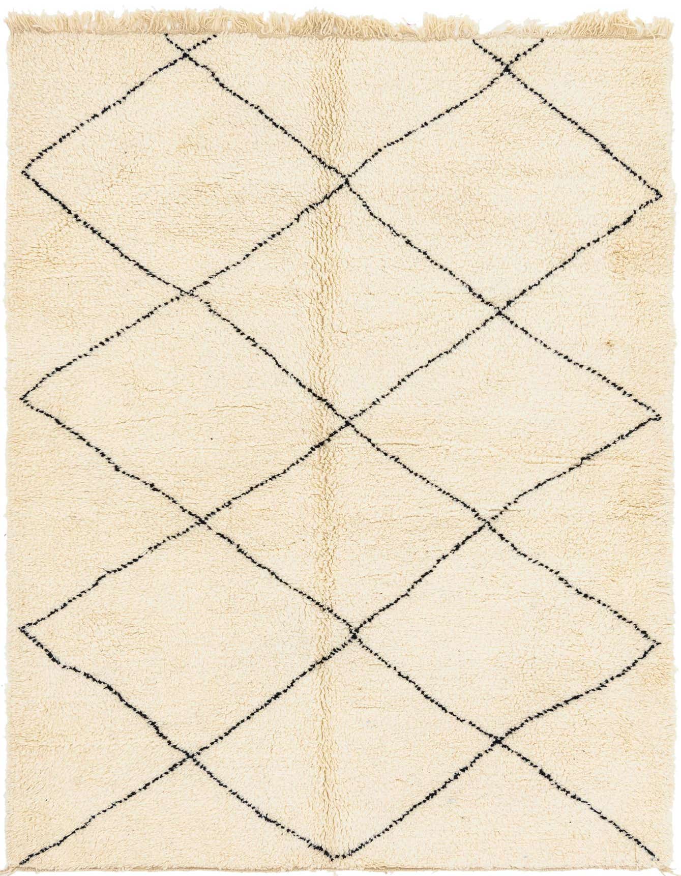 A 7x10 rectangular ivory shag rug with a black tribal diamond pattern and fringe, perfect for a living room.