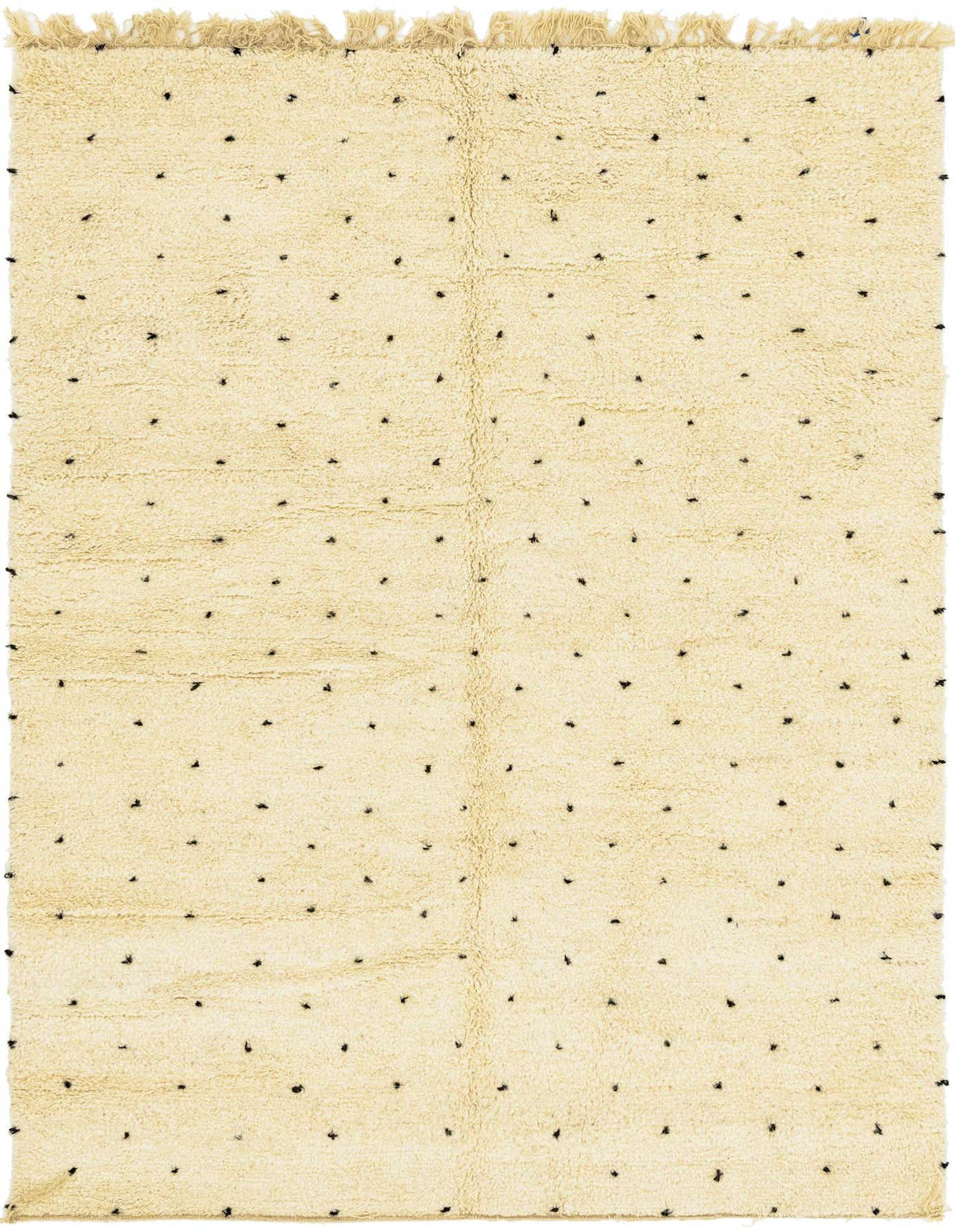 A 6x9 rectangular ivory shag rug with small, scattered black tribal dots and fringed edges.