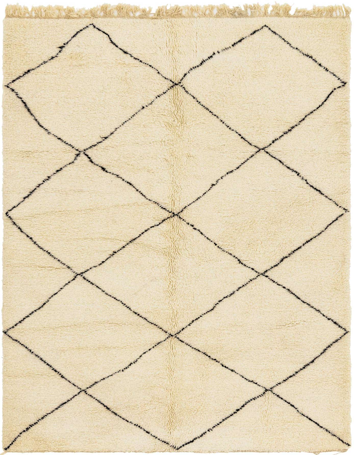 A 6x9 rectangular ivory shag rug with a black tribal diamond pattern and fringe, suitable for a living room.