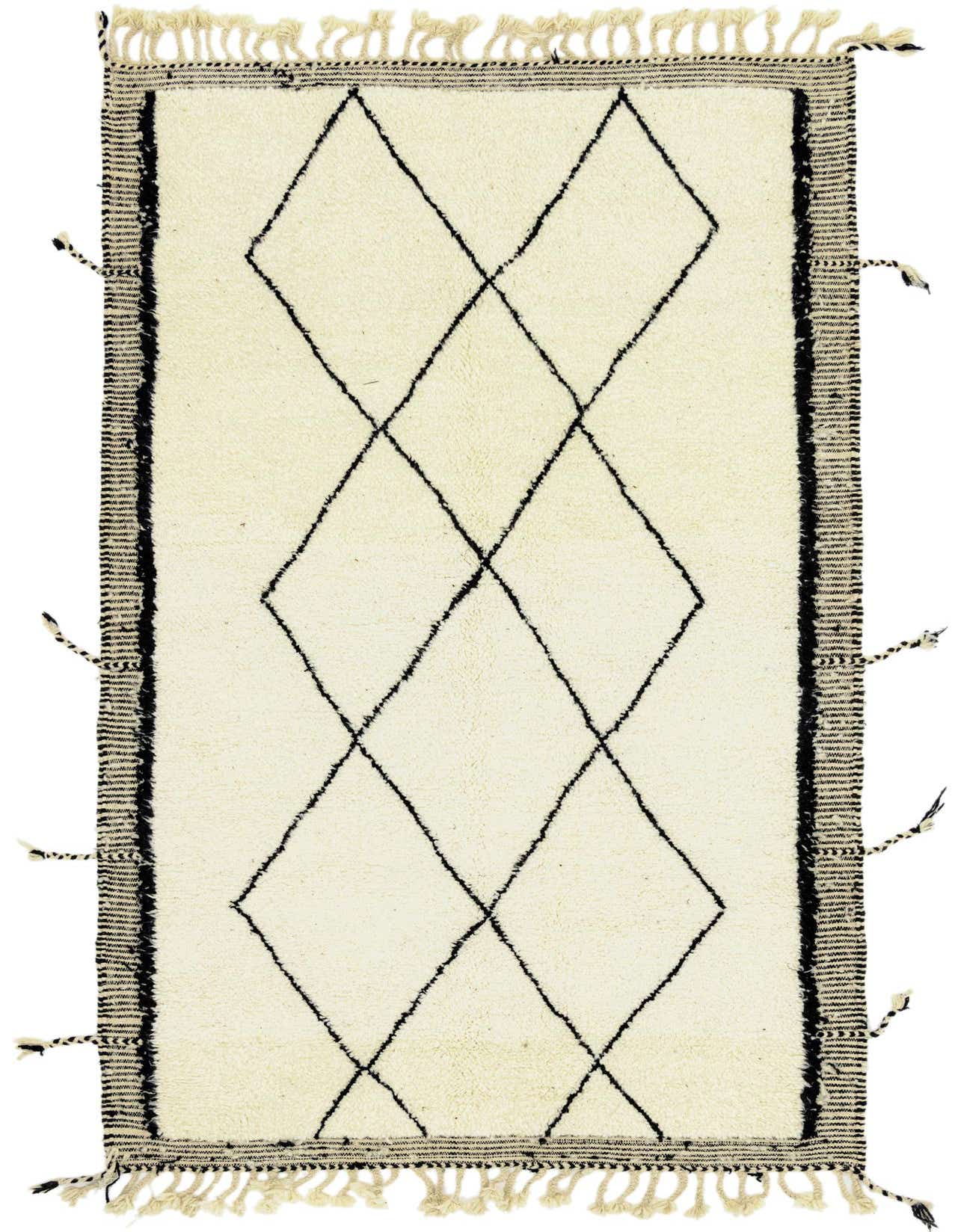 A 5x8 rectangular ivory shag rug with a black tribal diamond pattern and fringed edges, suitable for a living room.